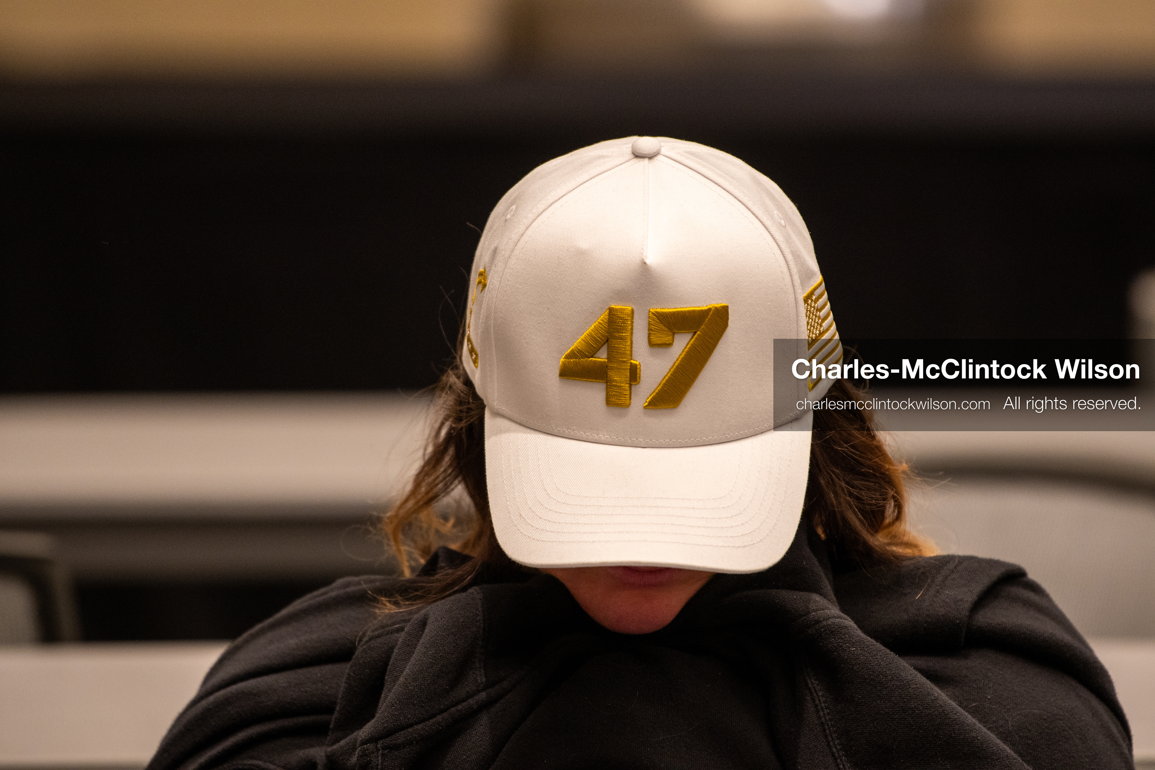 December 18, 2025, Phoenix, Arizona, USA: An attendee rests with head down in a lecture hall during AmericaFest 2025 at the Phoenix Convention Center, wearing a white cap embroidered with 47 in gold, a reference to US President Donald Trump. (Credit Image: © Charles-McClintock Wilson/ZUMA Press Wire)