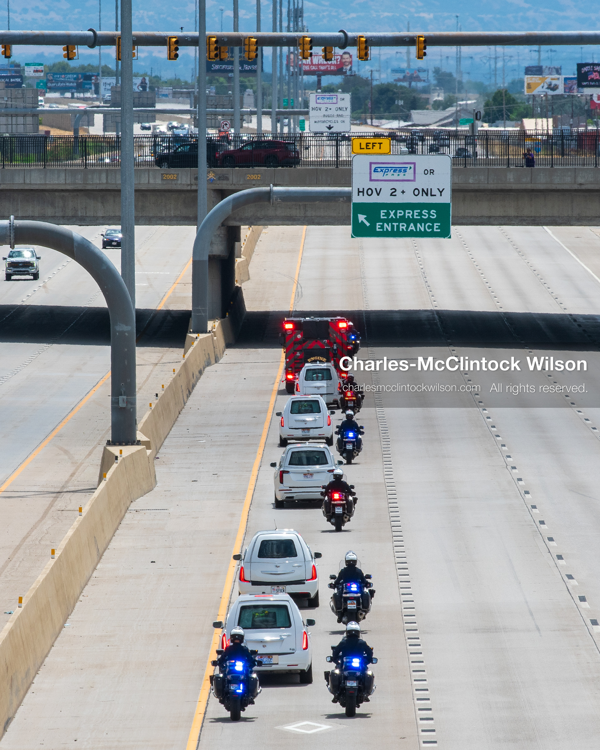 A motorcade of white hearses travels down Interstate 15 during a funeral procession for Provo Fire Captain Spencer Long and his family in Orem, Utah, on Wednesday, July 29, 2026. More than 300 people came to the public memorial ceremony to honor the five family members who died after a flash flood hit their campsite near the Sunglow Campground in Wayne County. (Photo by Charles-McClintock Wilson/Sipa USA)