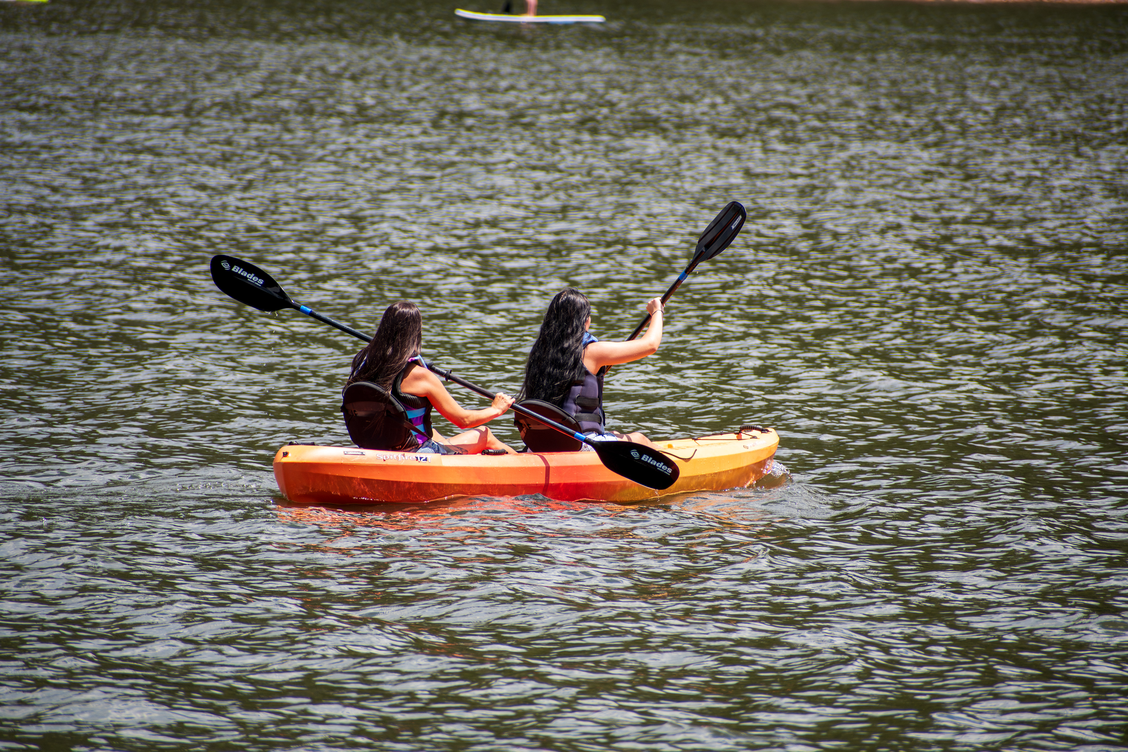 Summit County, Utah – July 20, 2025: People paddle kayaks across the calm waters of Smith and Morehouse Reservoir during a summer outing.