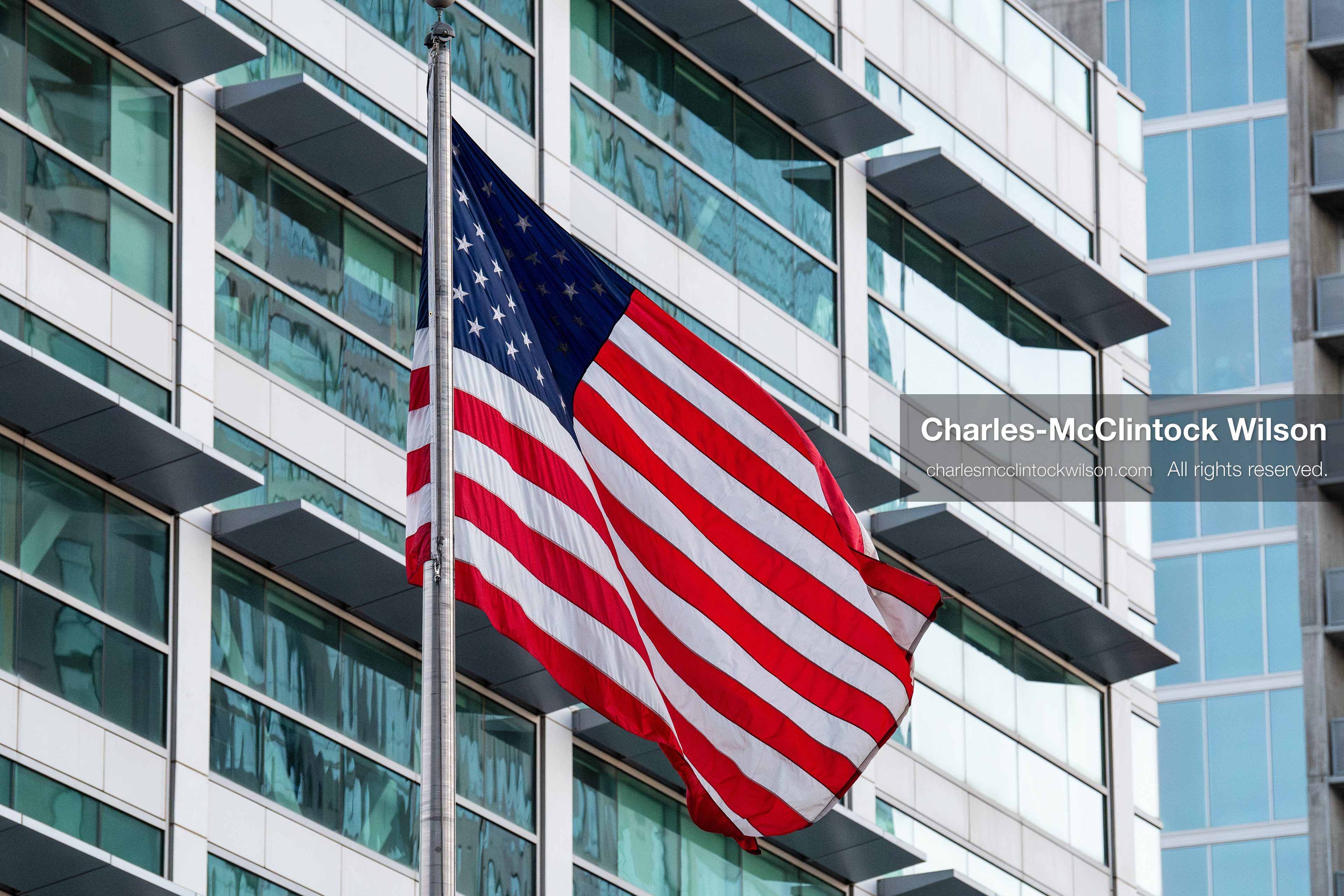 January 5, 2026, Salt Lake City, Utah, USA: The US flag flies outside the Wallace Federal Building during a protest on January 5, 2026. The rally, organized by Salt Lake Indivisible, called for congressional limits on presidential war powers following recent US military actions in Venezuela involving the government of Nicolas Maduro. Attendees signed petitions addressed to Utah US senators Mike Lee and John Curtis. (Credit Image: (c) Charles‑McClintock Wilson/ZUMA Press Wire)