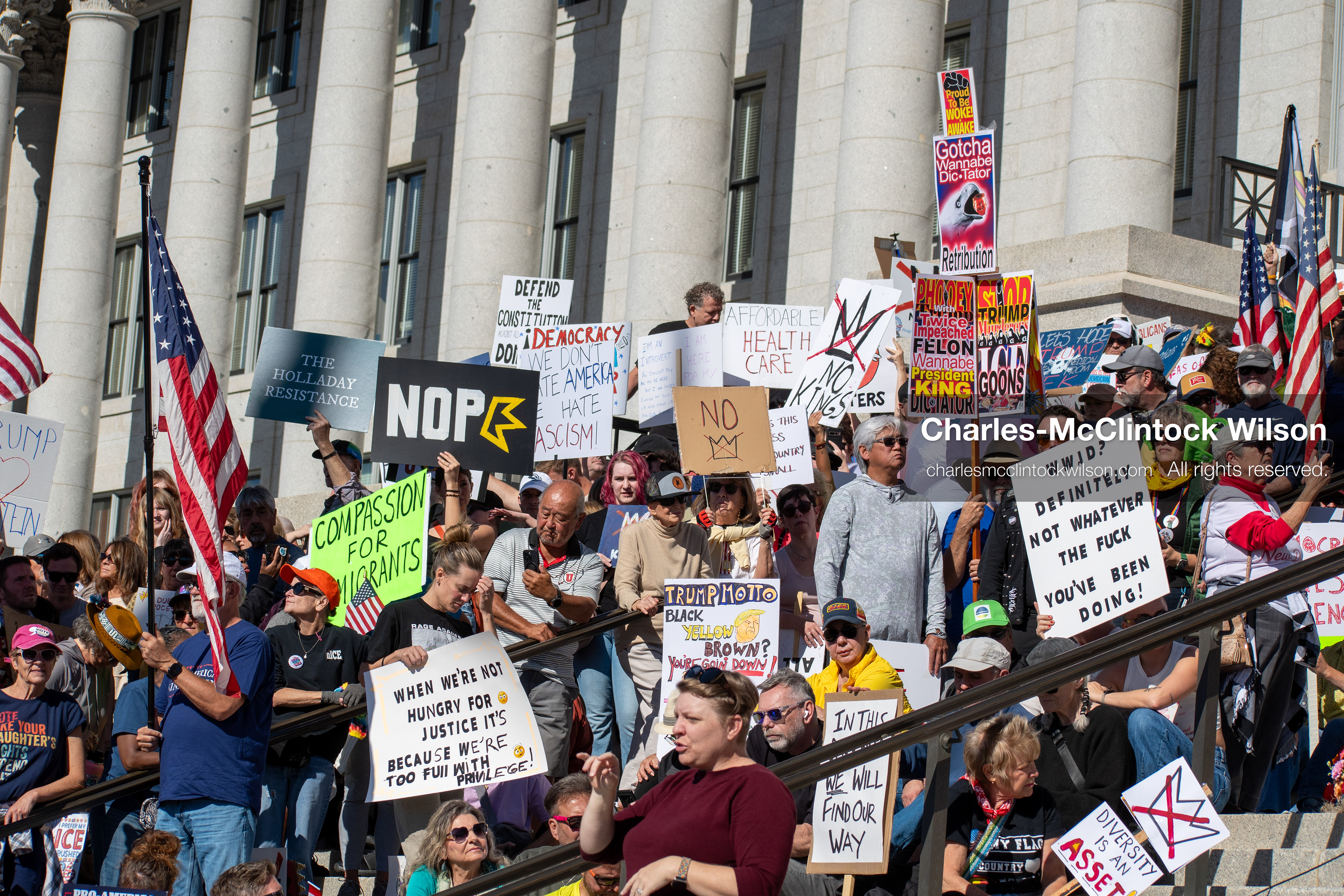 October 18, 2025, Salt Lake City, Utah, USA: Demonstrators participate in a "No Kings" protest held at the Utah State Capitol. Participants hold signs and flags during the public gathering.