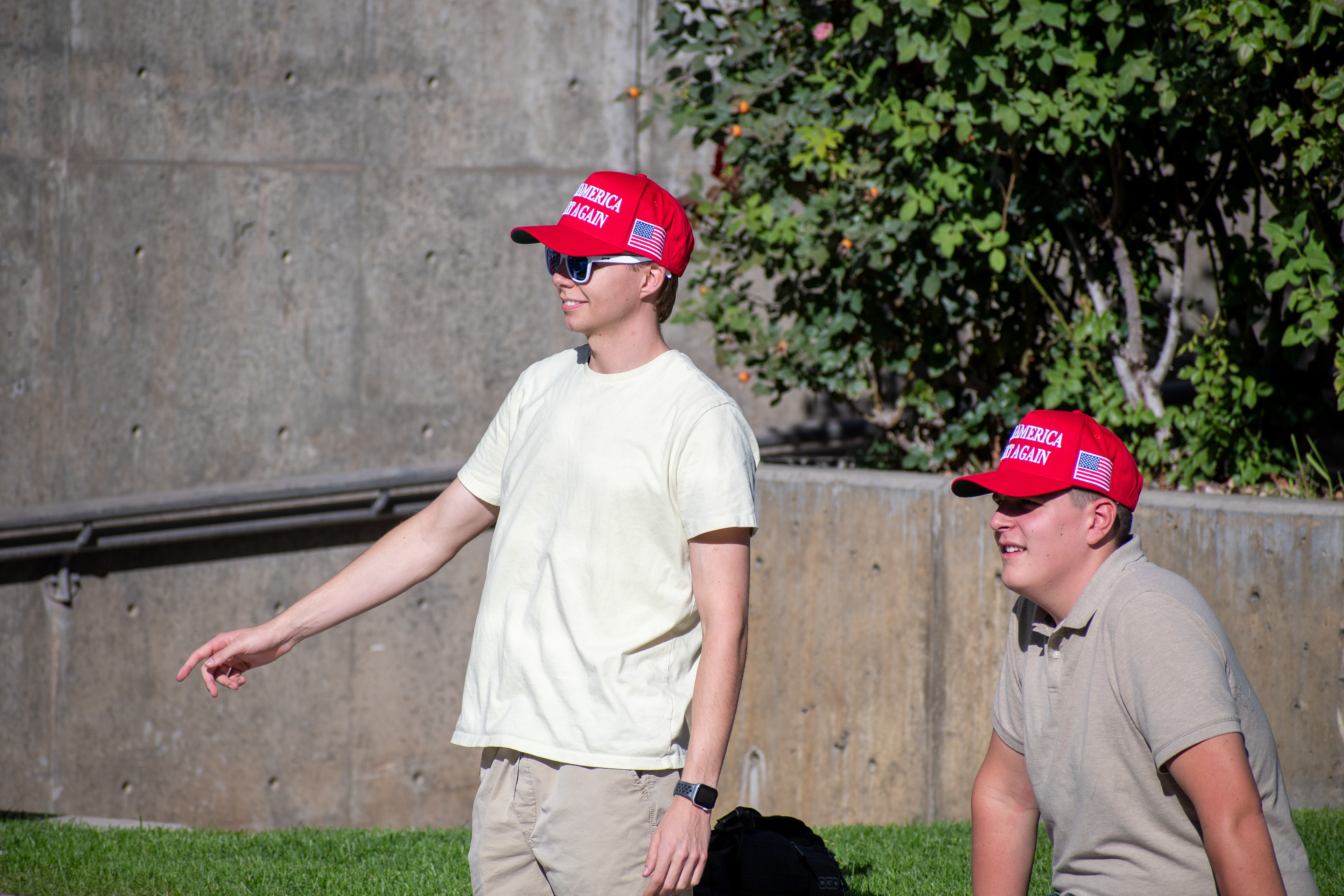 OREM, UTAH – SEPTEMBER 10, 2025: Two attendees sit on the lawn at Utah Valley University during the opening stop of the American Comeback Tour. Framed in relaxed conversation and reflective posture, the image captures a moment of casual presence, shared energy, and civic engagement. © Charles-McClintock Wilson / ZUMA Press