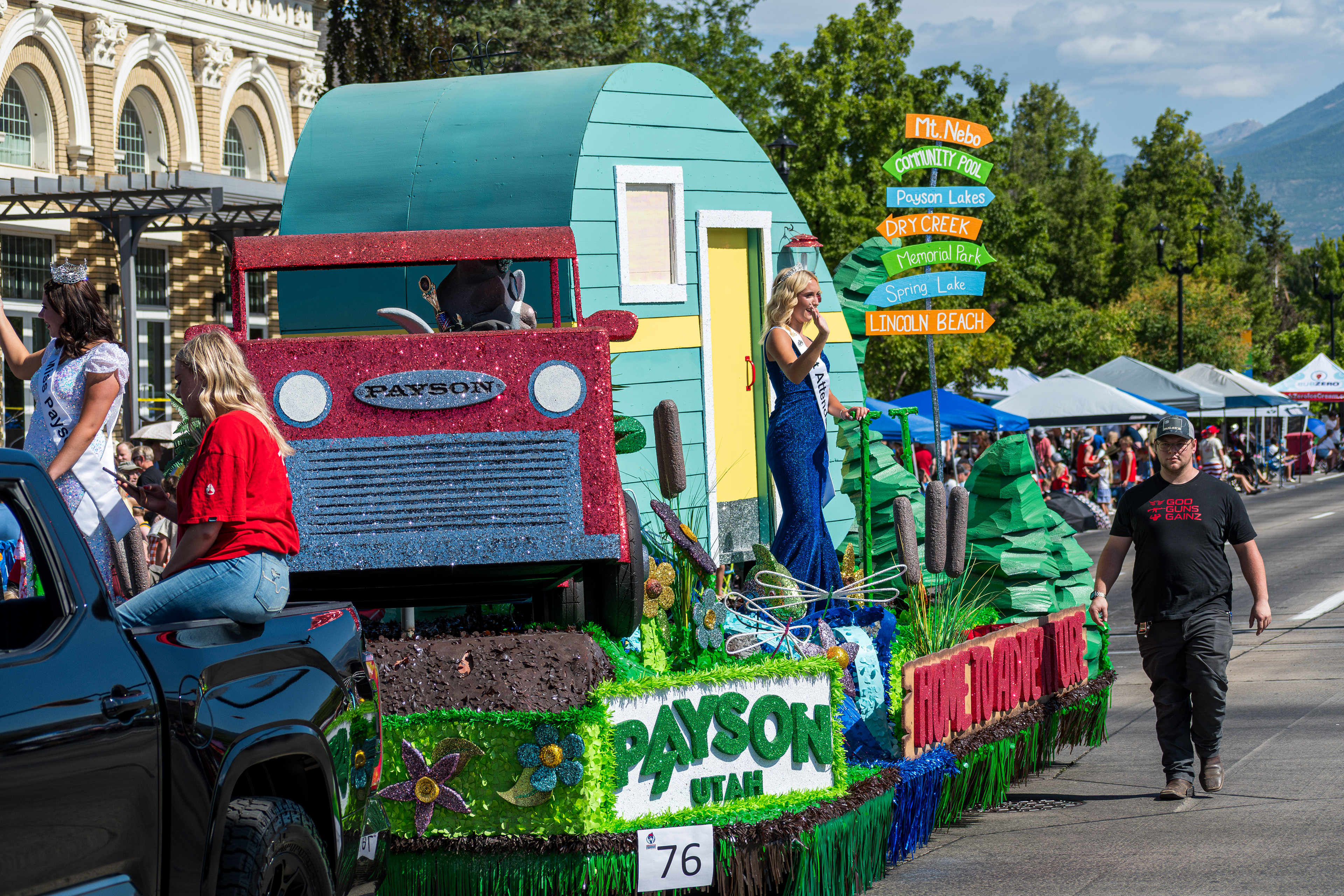 PROVO, UTAH – JULY 4, 2025: A young woman wearing a sash labeled "1st Attendant" waves to spectators from the Payson City float during the America’s Freedom Festival Grand Parade.