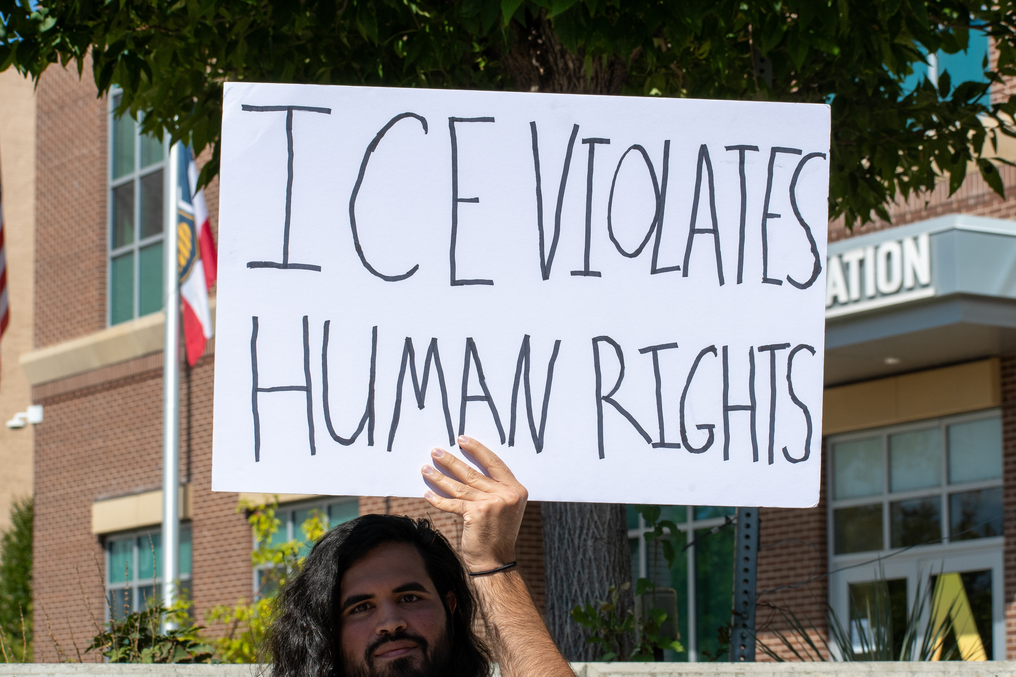 September 15, 2025 – Provo, Utah, United States: A demonstrator holds a sign reading “ICE VIOLATES HUMAN RIGHTS” outside the Utah Valley Convention Center during a protest against the Department of Homeland Security career expo. The message calls attention to immigration enforcement practices and their perceived impact on civil liberties. Photograph by Charles‑McClintock Wilson / ZUMA Press Wire