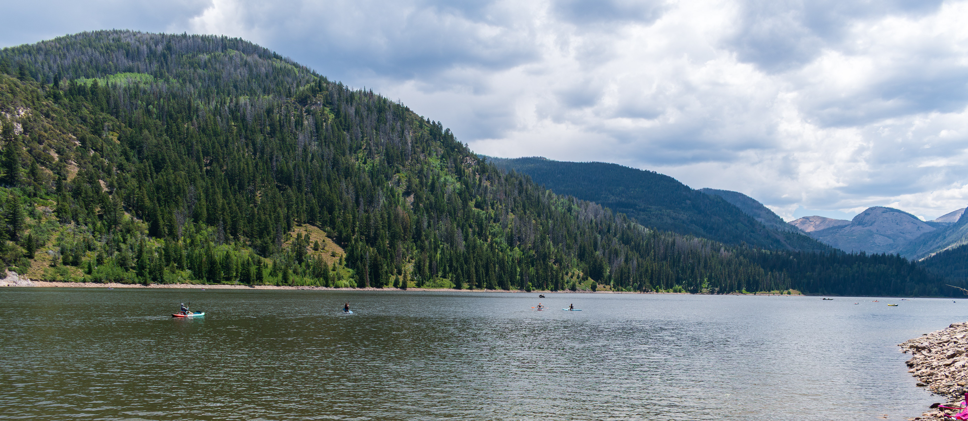 Summit County, Utah – July 20, 2025: People enjoy outdoor recreation on kayaks and paddleboards at Smith and Morehouse Reservoir.