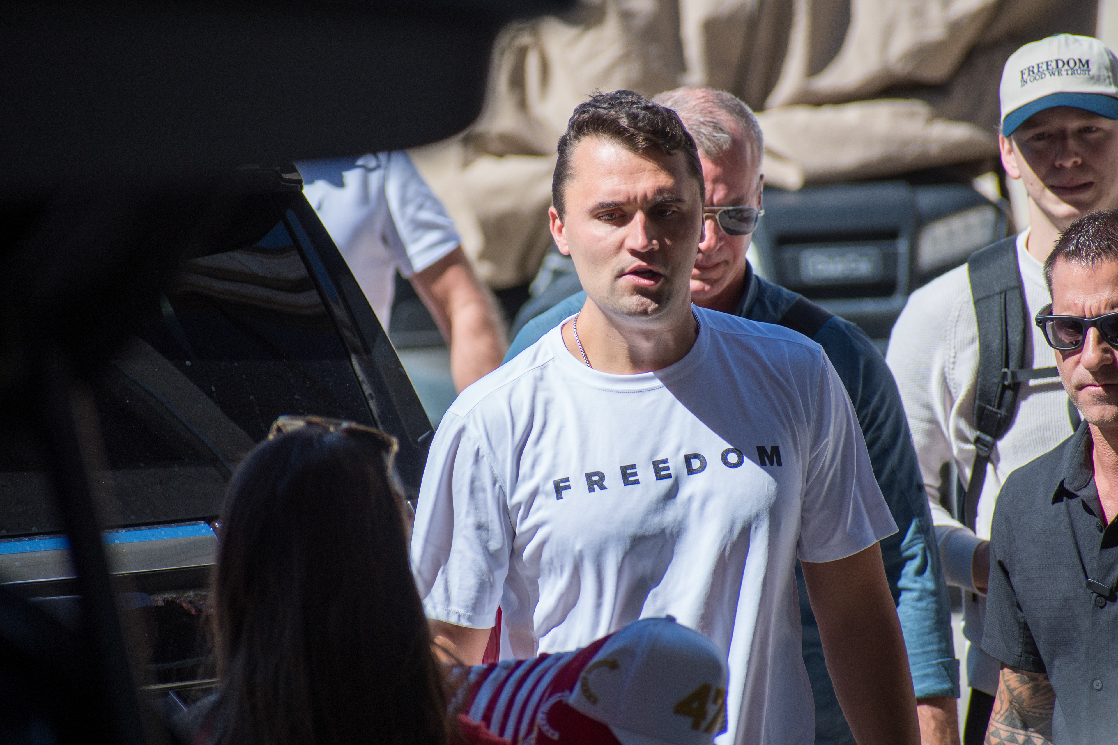 OREM, UTAH – SEPTEMBER 10, 2025: Charlie Kirk arrives at Utah Valley University for a scheduled public event. Wearing a shirt emblazoned with the word “FREEDOM,” Kirk walks among supporters and staff in a moment of visible anticipation. The image marks the beginning of his final public appearance, capturing the atmosphere of civic energy and symbolic presence that defined the day. © Charles-McClintock Wilson / ZUMA Press