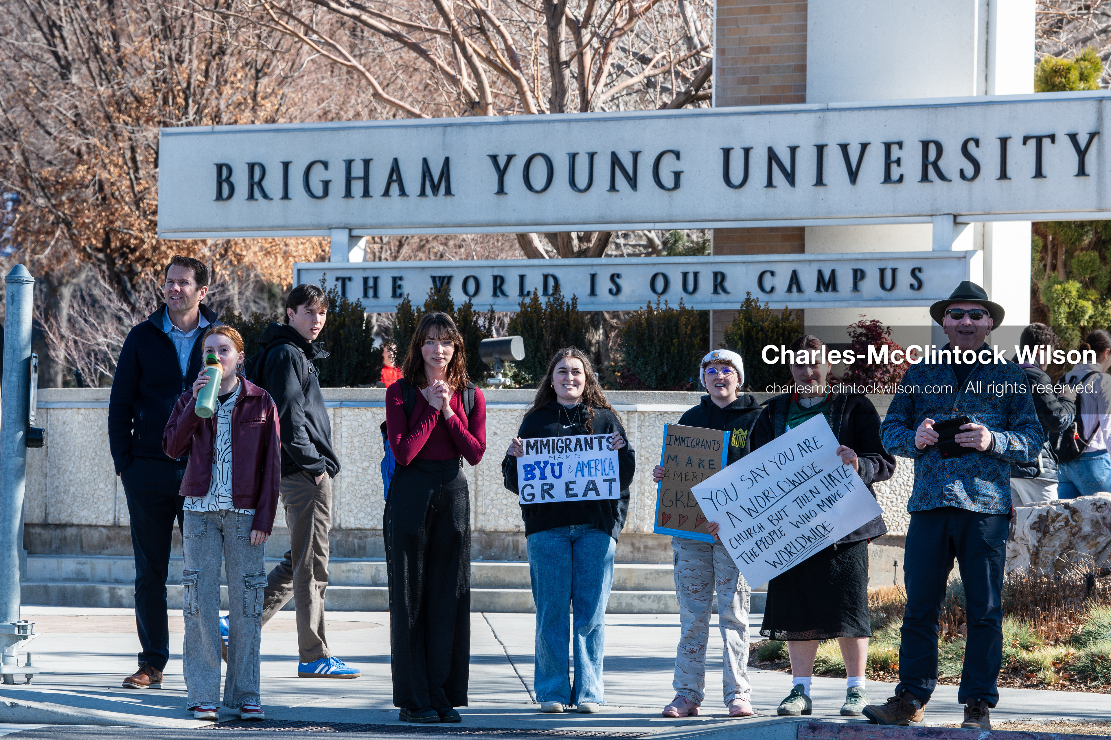 February 5, 2026, Provo, Utah, USA: People walk near the Brigham Young University entrance in Provo as demonstrators carrying signs gather to protest the presence of US Customs and Border Protection recruiters at a career fair held on the BYU campus. (Credit Image: © Charles McClintock Wilson/ZUMA Press Wire)