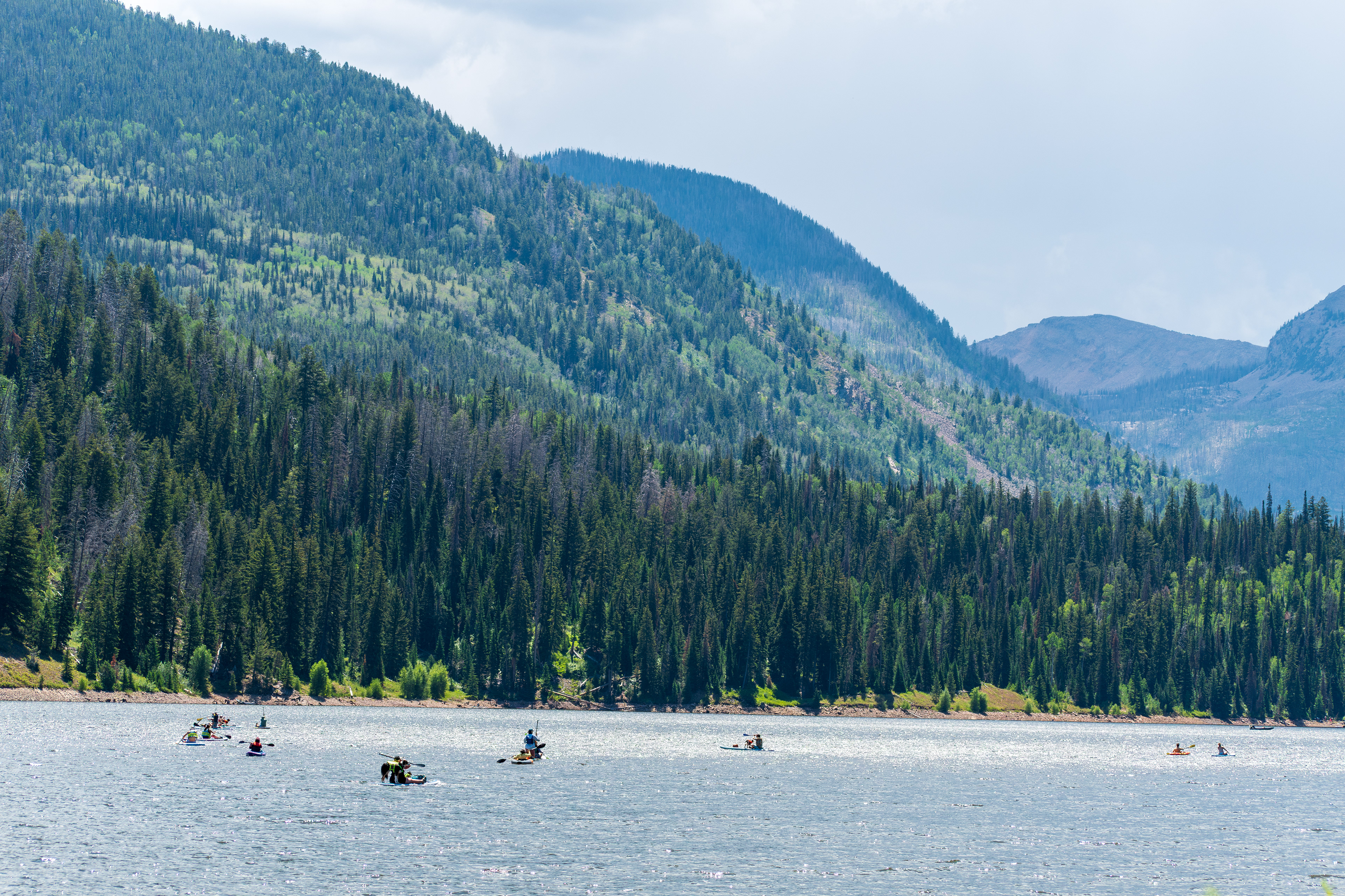 Summit County, Utah – July 20, 2025: People enjoy outdoor recreation on kayaks and paddleboards at Smith and Morehouse Reservoir.