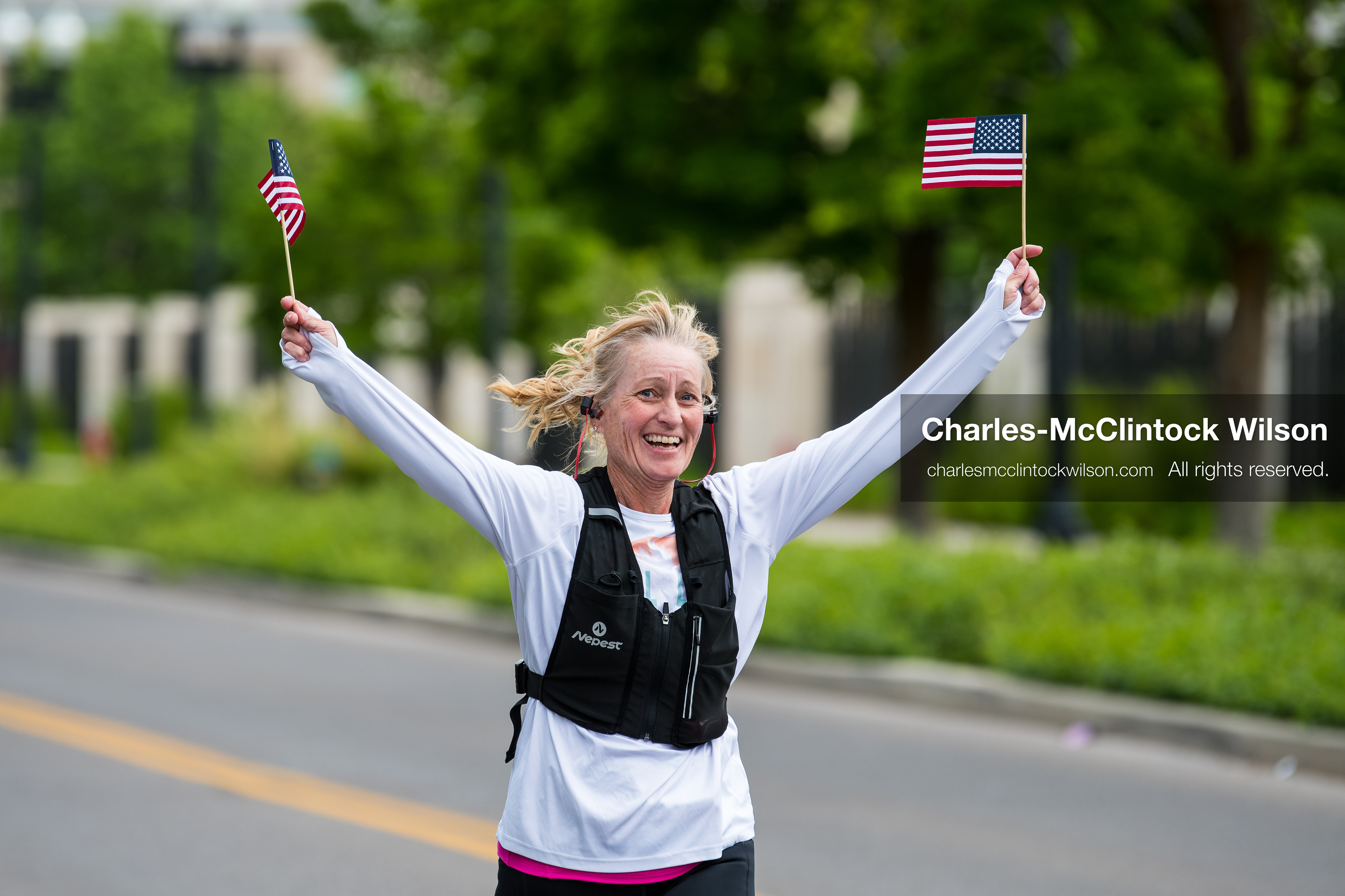 May 16, 2026, Ogden, Utah, USA: A runner waves two small American flags while participating in the 25th Annual America First Ogden Marathon in Ogden, Utah, on Saturday, May 16, 2026. The event marked the 25th running of the marathon, drawing thousands of participants and spectators. (Credit Image: © Charles-McClintock Wilson/ZUMA Press Wire)