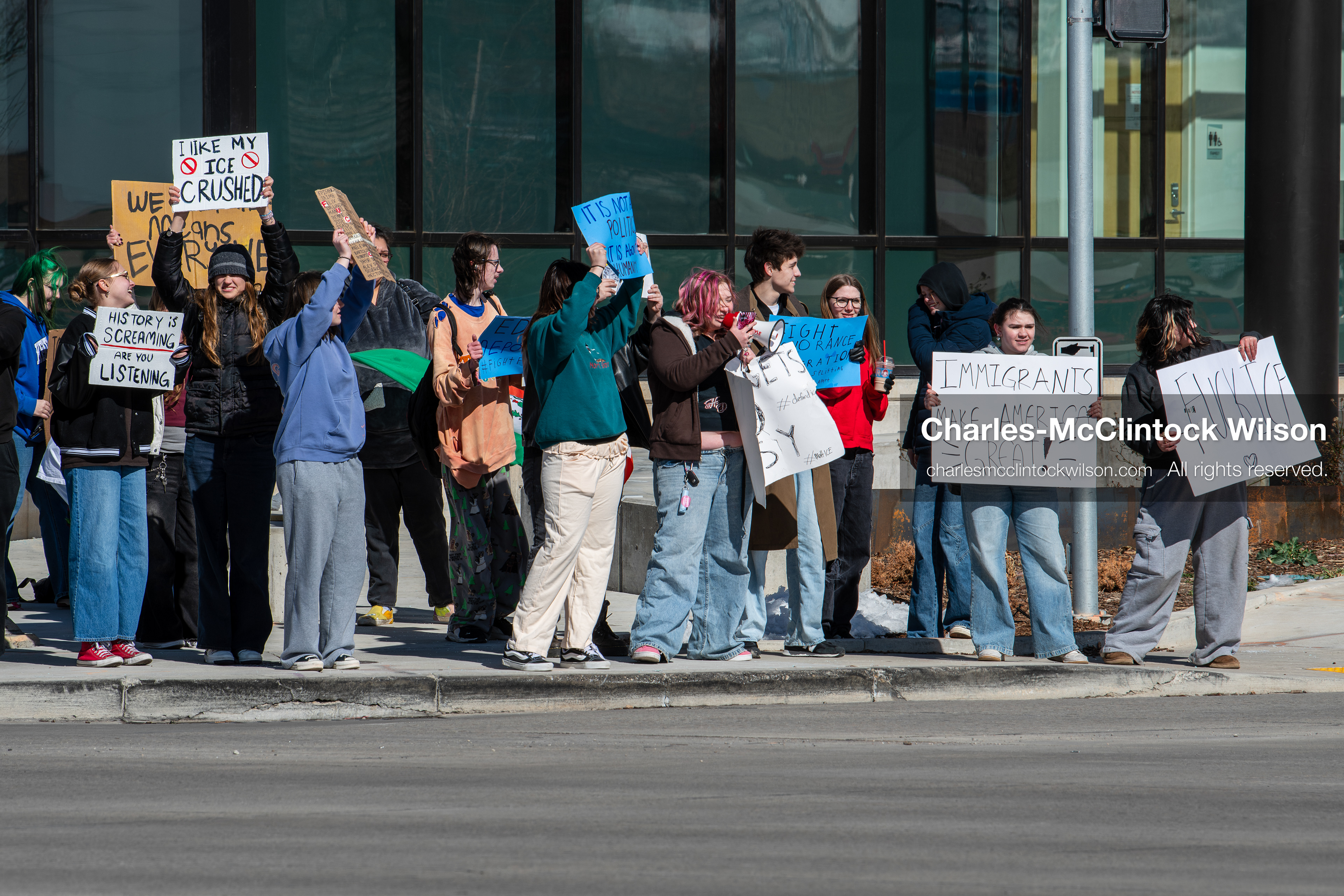 February 20, 2026, Orem, Utah, USA: High school students gather along State Street in front of Orem City Hall during a student led protest against ICE and federal immigration enforcement. Demonstrators hold signs as they stand near the roadway while traffic continues through the area. (Credit Image: © Charles McClintock Wilson/ZUMA Press Wire)