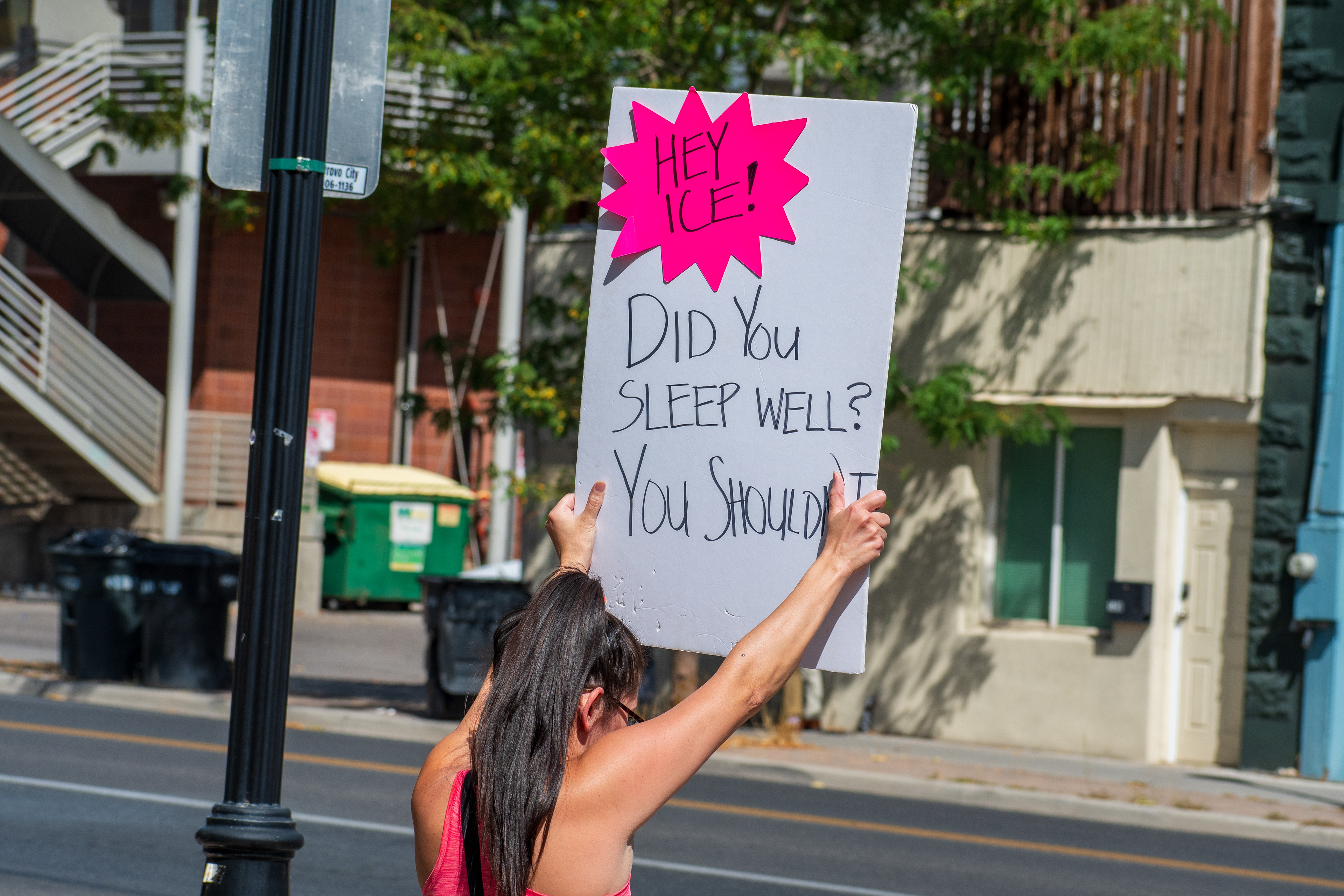 September 15, 2025 – Provo, Utah, United States: A demonstrator holds a sign reading “HEY ICE! DID YOU SLEEP WELL? YOU SHOULDN’T” outside the Utah Valley Convention Center during a protest against the Department of Homeland Security career expo. The message challenges immigration enforcement practices and evokes moral accountability. Photograph by Charles‑McClintock Wilson / ZUMA Press Wire