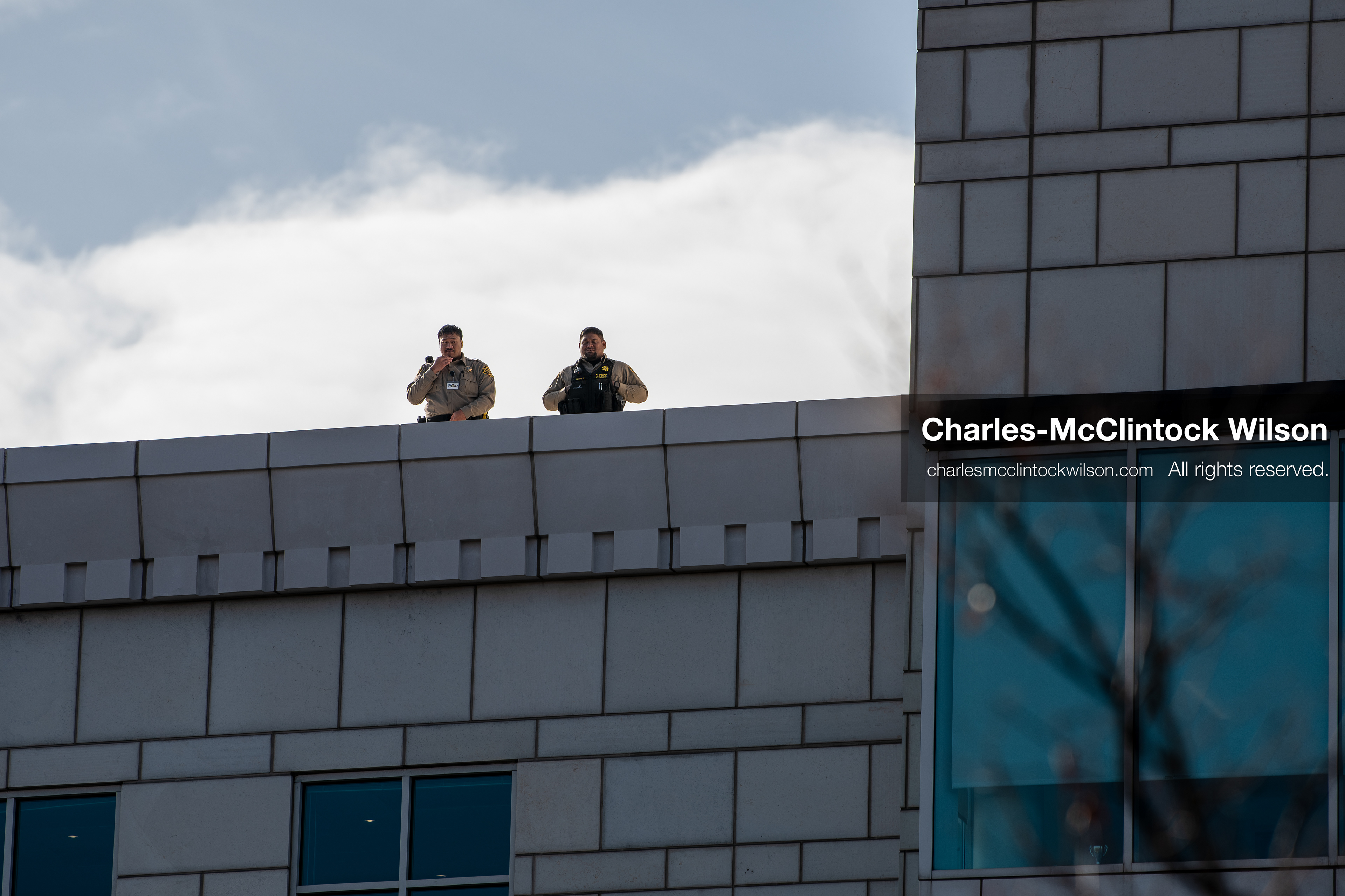 January 30, 2026, Salt Lake City, Utah, USA: Uniformed personnel stand on a rooftop overlooking the scene during an anti‑ICE protest in Salt Lake City, part of a nationwide response to immigration enforcement policies. (Credit Image: © Charles‑McClintock Wilson/ZUMA Press Wire)