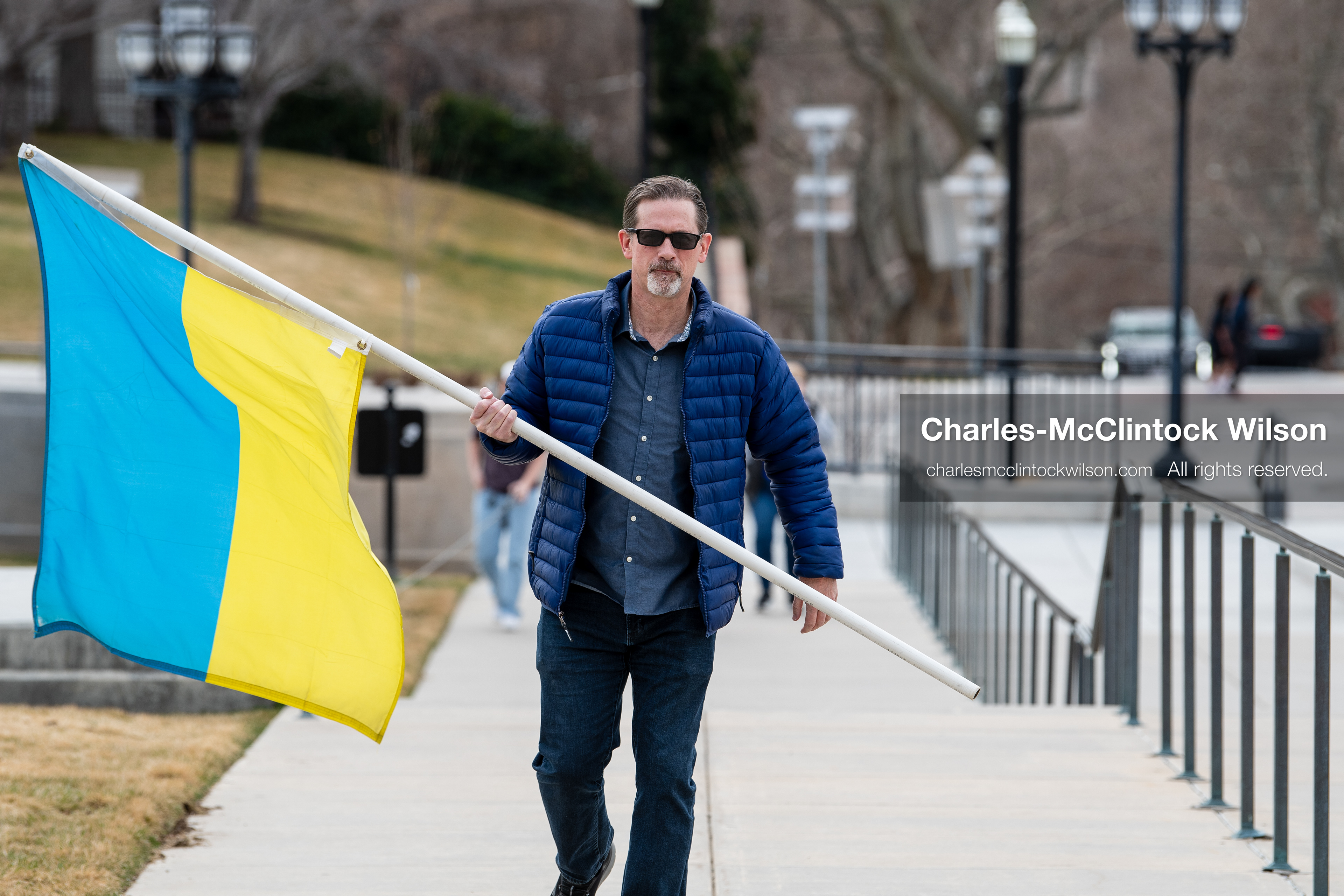 February 28, 2026, Salt Lake City, Utah, USA: JOHN BOYD, a Utah Forward Party candidate for Utah House District 53, carries a large Ukrainian flag while walking near the Utah State Capitol during the Stand With Ukraine rally. The gathering marked the four year anniversary of the full scale Russian invasion of Ukraine and brought community members together in support of Ukrainians and local humanitarian efforts. (Credit Image: © Charles McClintock Wilson/ZUMA Press Wire)
