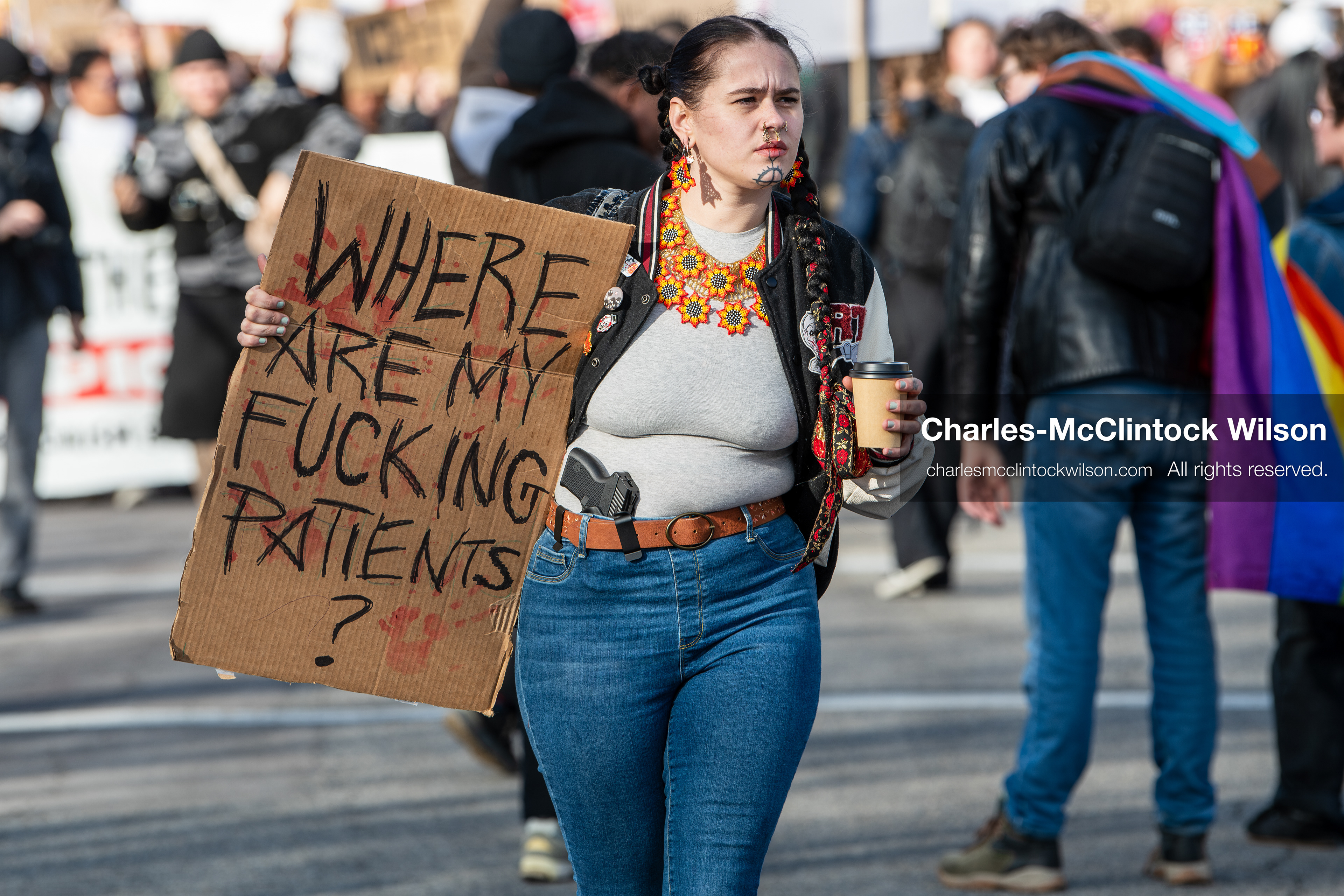 January 30, 2026, Salt Lake City, Utah, USA: A demonstrator carries a firearm positioned at her waist while holding a sign during an anti‑ICE protest in Salt Lake City, part of a nationwide response to immigration enforcement policies. (Credit Image: © Charles‑McClintock Wilson/ZUMA Press Wire)