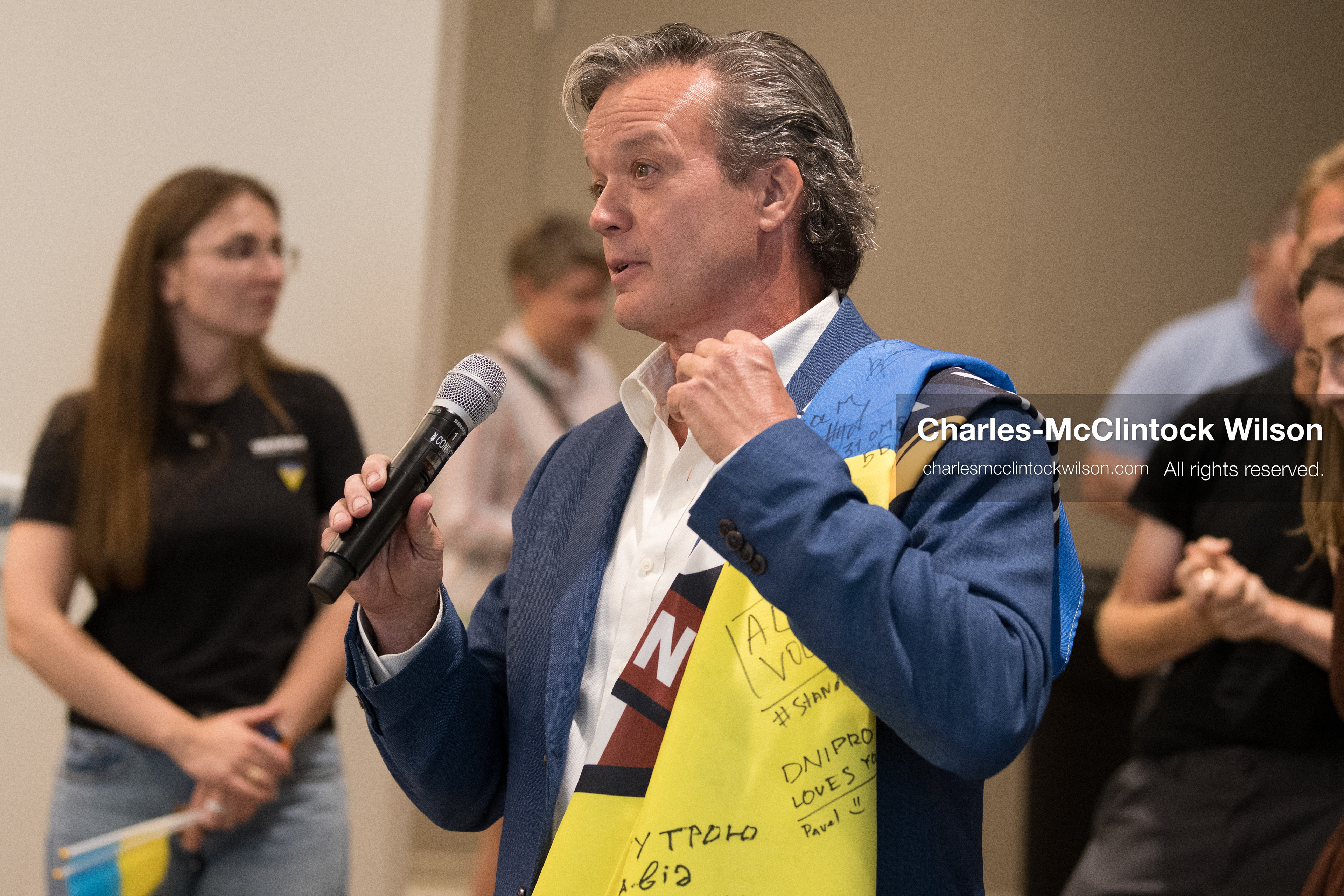 July 23, 2026, Salt Lake City, Utah, USA: An attendee speaks into a microphone while wearing a signed Ukrainian flag over his shoulders during a community meeting featuring Ukrainian activist Serhiy Prytula at the Utah State Capitol building in Salt Lake City, Utah, on Thursday, July 23, 2026. The event, titled ''Ukraine in the Fifth Year of the Full-Scale War: An Honest Conversation,'' was hosted by the Prytula Foundation USA to discuss civil defense and ongoing humanitarian aid initiatives. (Credit Image: © Charles-McClintock Wilson/ZUMA Press Wire)