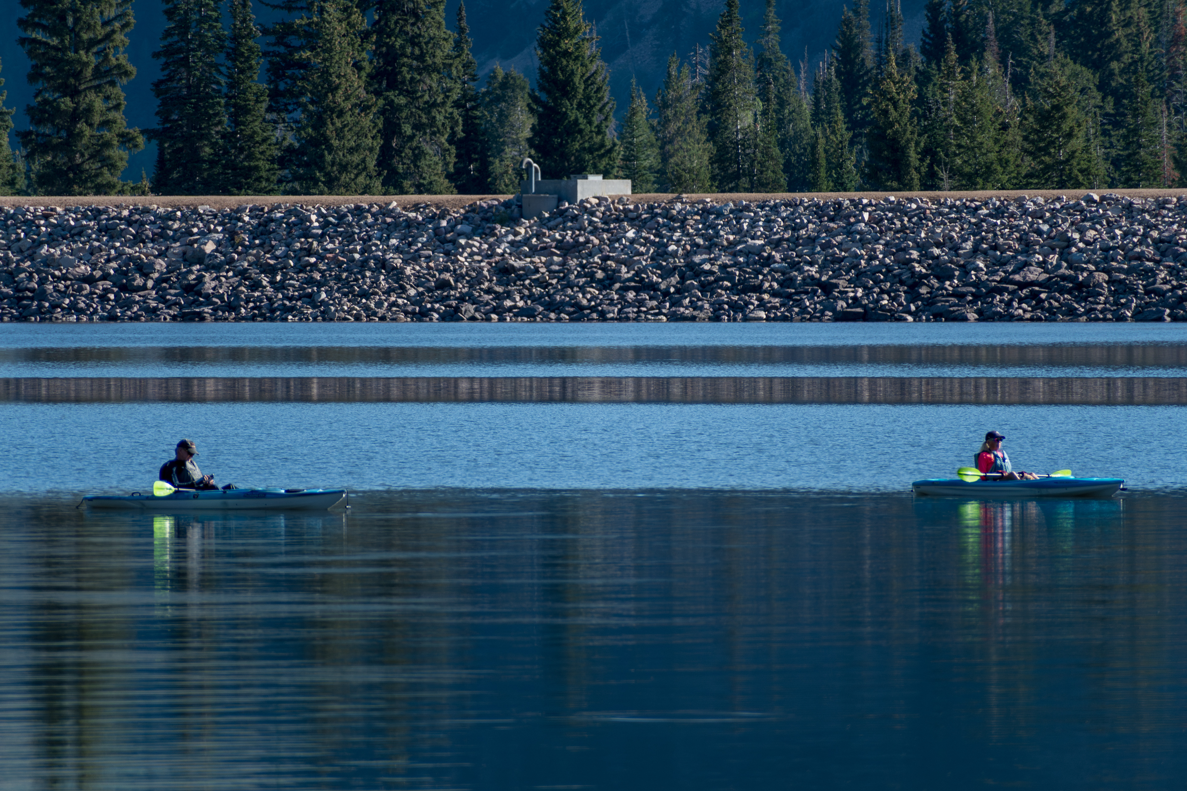 Summit County, Utah – July 20, 2025: People paddle kayaks across the calm waters of Smith and Morehouse Reservoir during a summer outing.