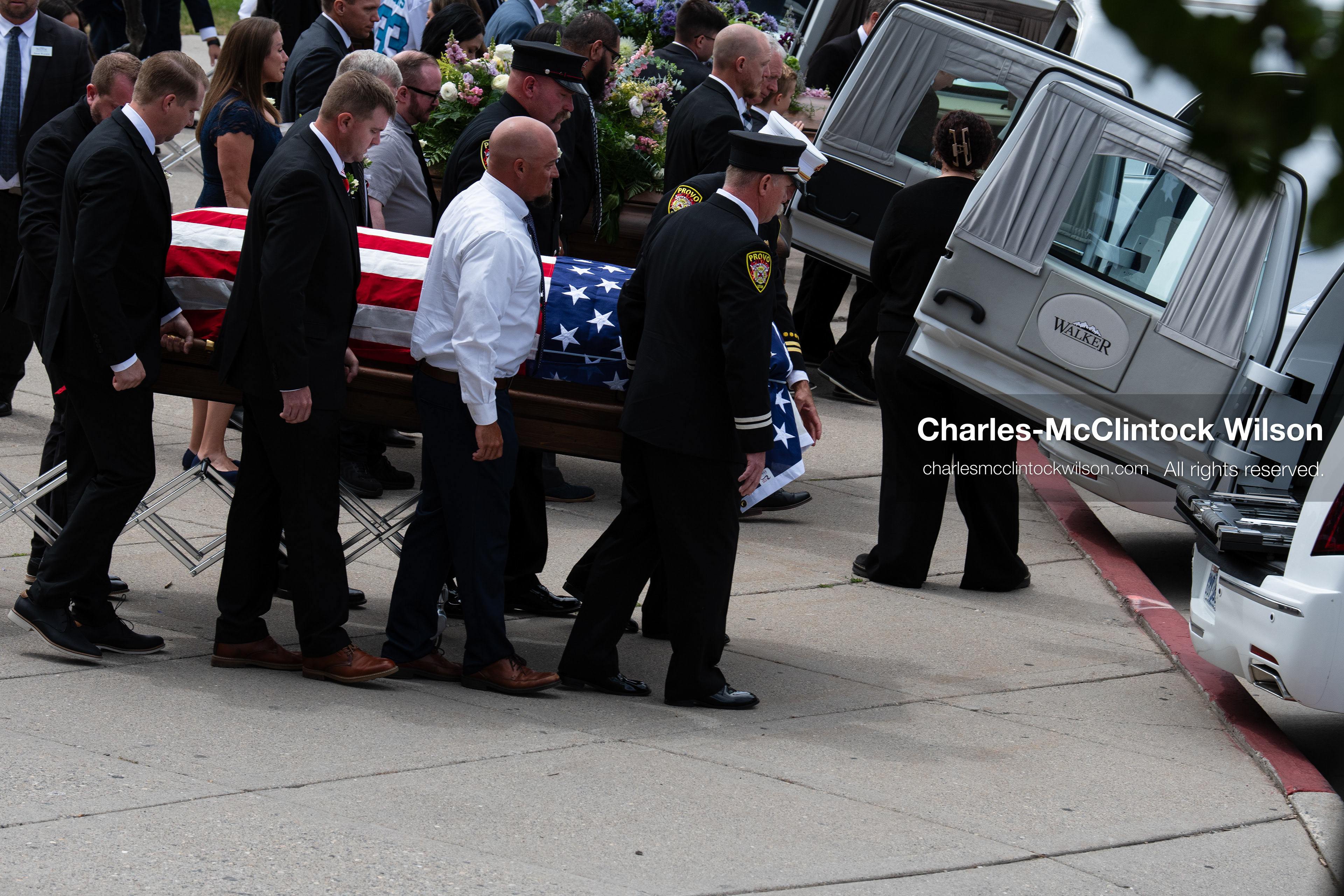 Firefighters and pallbearers load the flag-draped casket of Provo Fire Captain Spencer Long into a white hearse outside the UCCU Center at Utah Valley University in Orem, Utah, on Wednesday, July 29, 2026. More than 300 people came to the public memorial ceremony to honor Captain Long, his wife Katrina, and three of their sons, who died after a flash flood hit their campsite near the Sunglow Campground in Wayne County. (Photo by Charles-McClintock Wilson/Sipa USA)