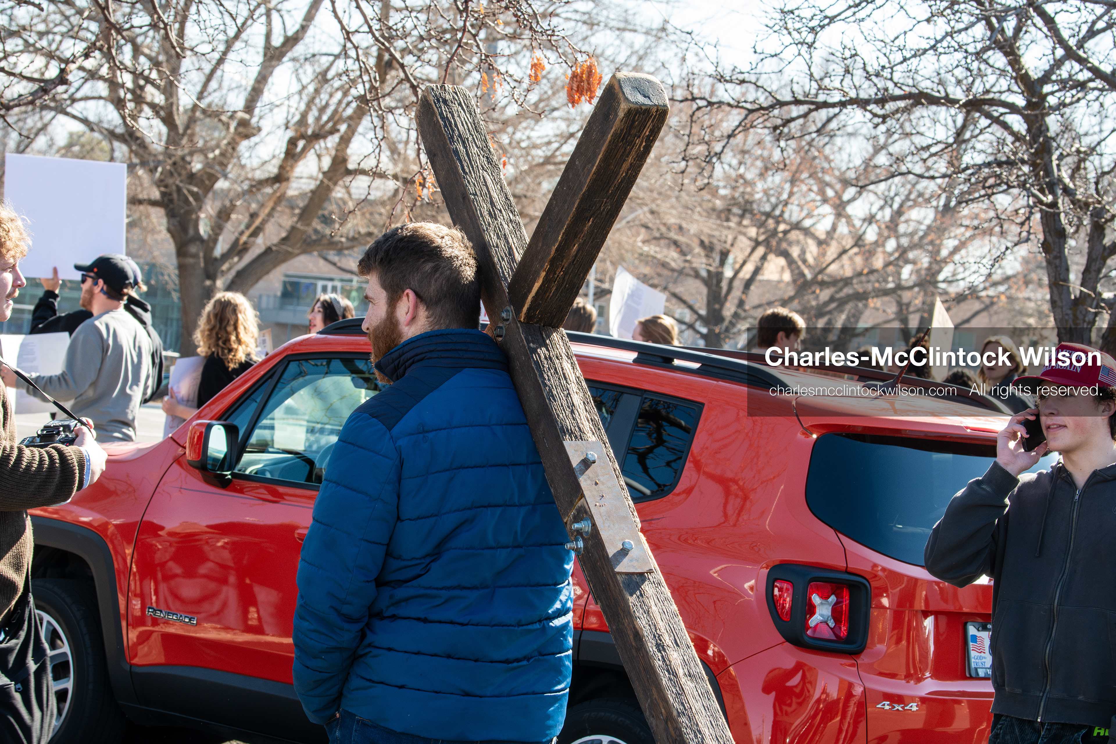 February 5, 2026, Provo, Utah, USA: A man carries a wooden cross while walking near Brigham Young University in Provo during a protest opposing the presence of US Customs and Border Protection recruiters at a career fair held on the BYU campus. (Credit Image: © Charles McClintock Wilson/ZUMA Press Wire)
