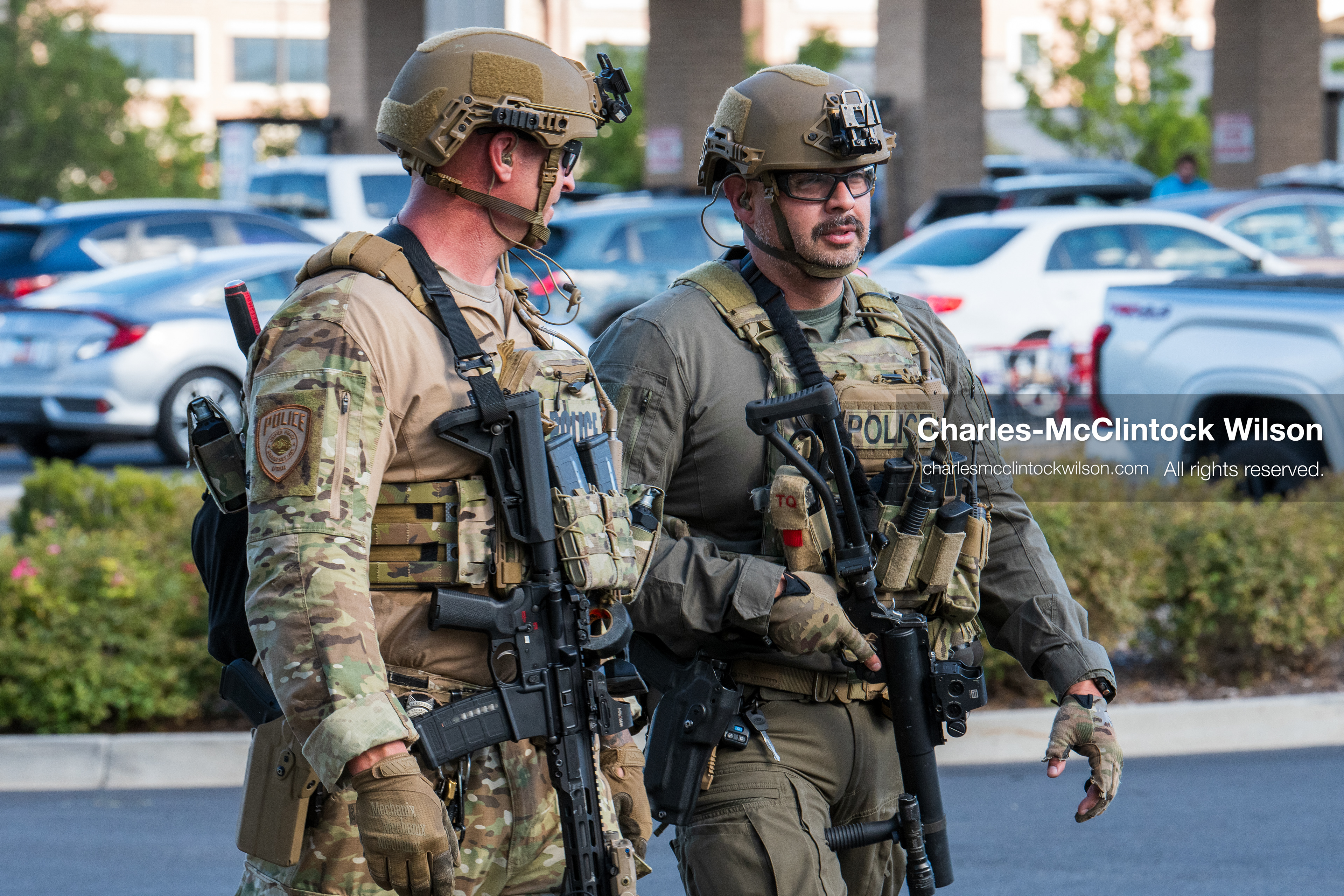 Two armed law enforcement officers in tactical gear and helmets patrol the parking area outside Intermountain Medical Center in Murray, Utah, on Monday, August 17, 2026. Multiple regional law enforcement agencies converged to heavily secure the hospital perimeter as a safety precaution after shooting victims arrived from a fatal shootout that erupted outside a funeral service in nearby Kearns earlier that day. (Photo by Charles-McClintock Wilson/Sipa USA)
