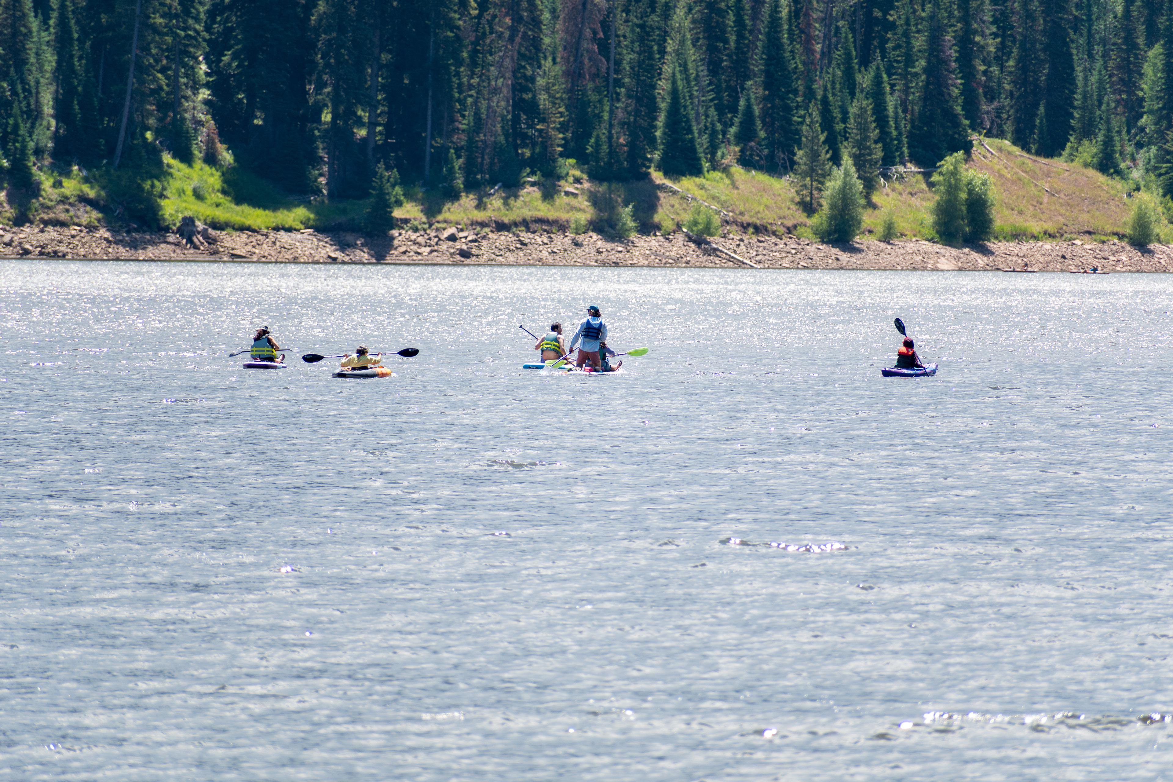 Summit County, Utah – July 20, 2025: People enjoy outdoor recreation on kayaks and paddleboards at Smith and Morehouse Reservoir.
