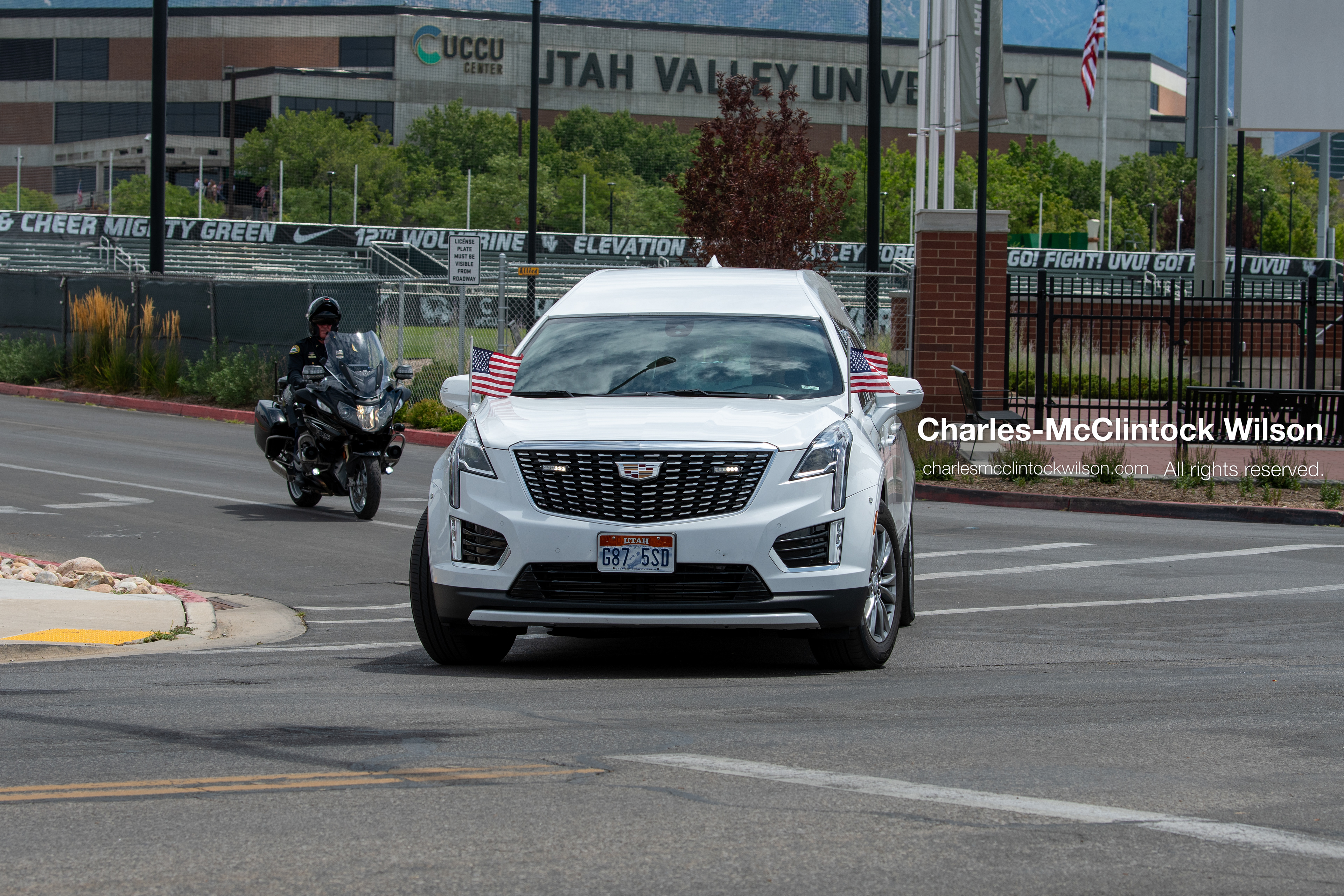 A white Cadillac hearse leads a vehicle procession down the street away from the UCCU Center at Utah Valley University in Orem, Utah, on Wednesday, July 29, 2026. More than 300 people came to the public memorial ceremony to honor Provo Fire Captain Spencer Long, his wife Katrina, and three of their sons, who died after a flash flood hit their campsite near the Sunglow Campground in Wayne County.(Photo by Charles-McClintock Wilson/Sipa USA)