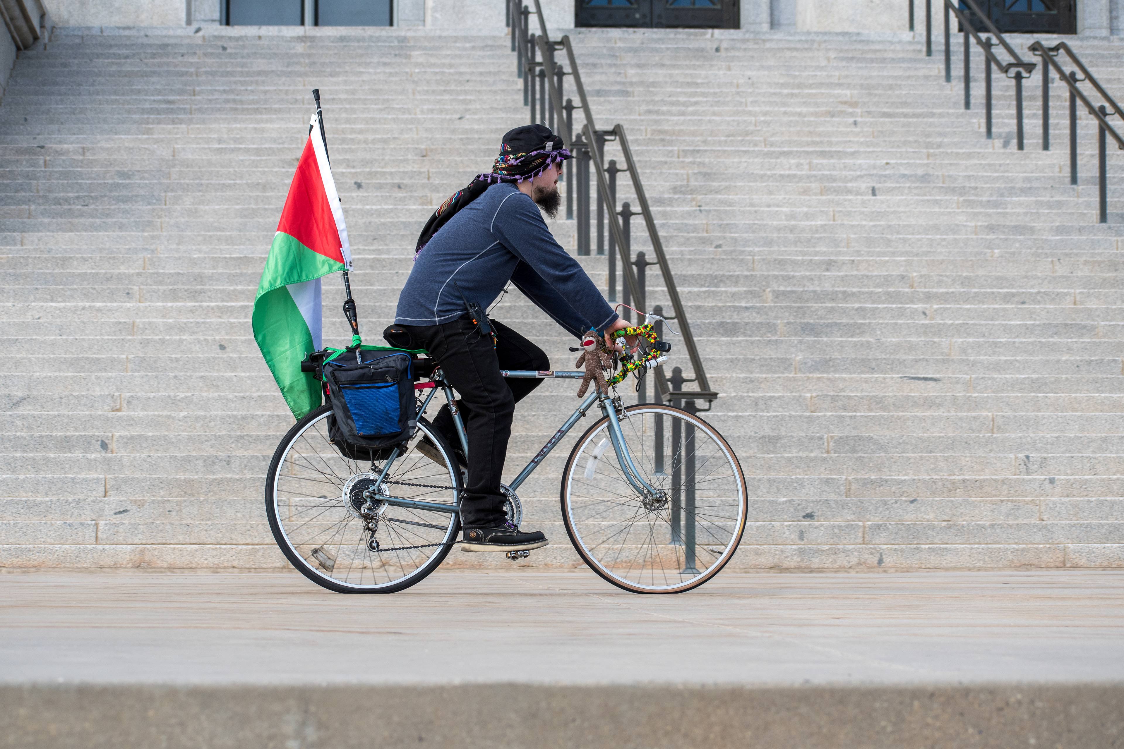 October 10, 2025, Salt Lake City, Utah, USA: A demonstrator rides past the Utah State Capitol during the Free Palestine Rally. A Palestinian flag is mounted to the bicycle. (Credit Image: © Charles-McClintock Wilson/ZUMA Press Wire)