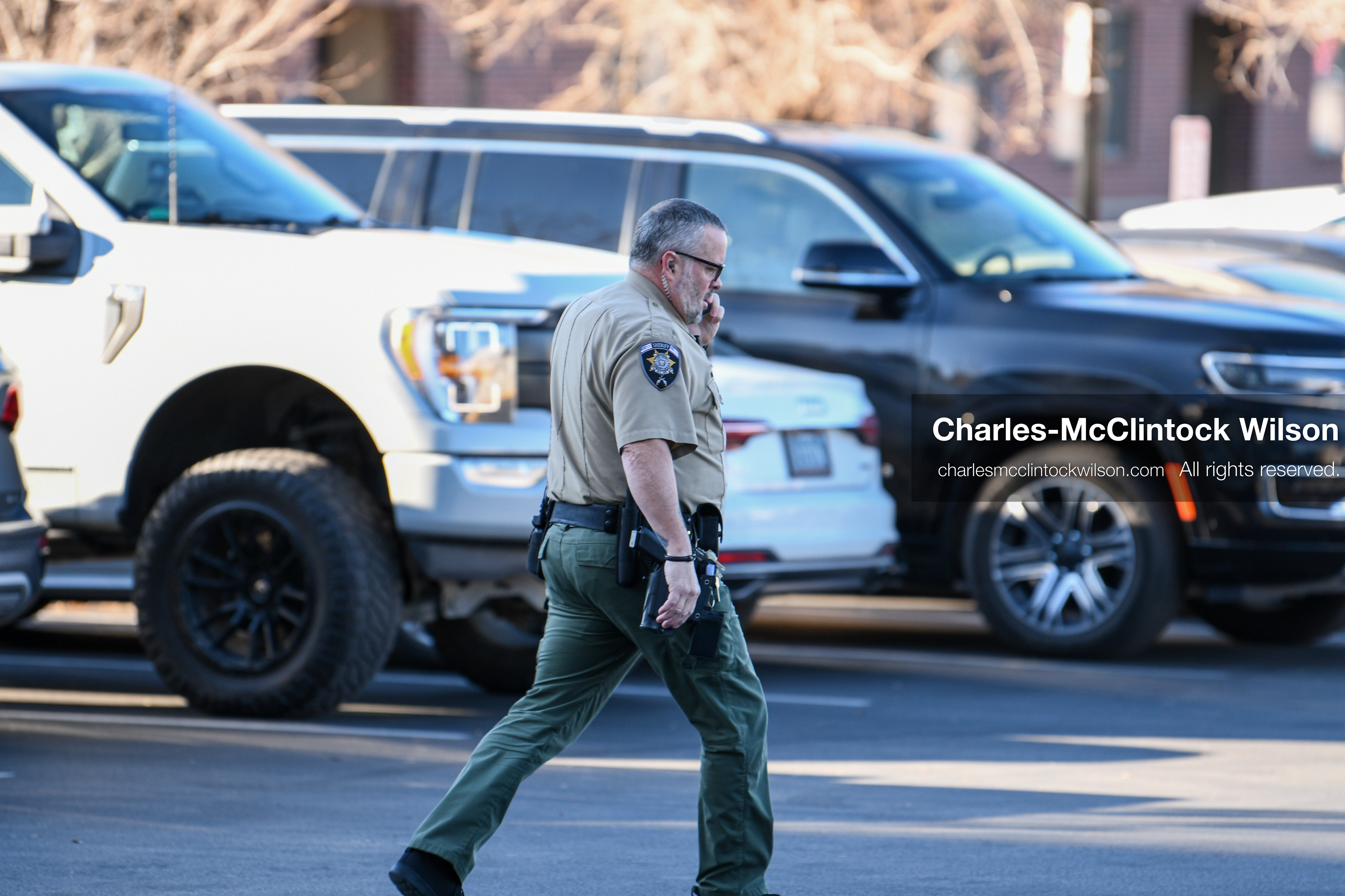 PROVO, UTAH, USA – DECEMBER 11, 2025: A Utah County Sheriff’s Office officer patrols the parking lot of the Fourth District Court in Provo during the first in‑person court appearance of Tyler Robinson in the Charlie Kirk murder case. (Credit Image: © Charles‑McClintock Wilson/ZUMA Press Wire)