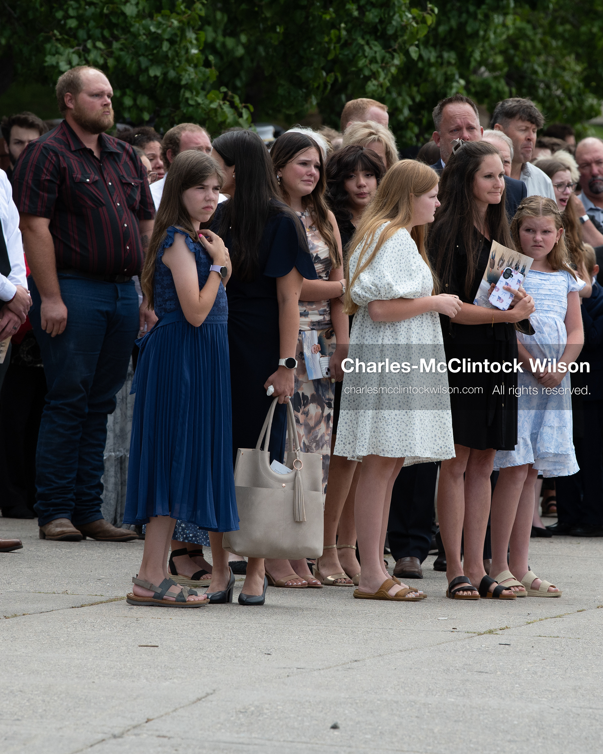 Mourners stand in a crowd outside the UCCU Center at Utah Valley University in Orem, Utah, on Wednesday, July 29, 2026. More than 300 people came to the public memorial ceremony to honor Provo Fire Captain Spencer Long, his wife Katrina, and three of their sons, who died after a flash flood hit their campsite near the Sunglow Campground in Wayne County. (Photo by Charles-McClintock Wilson/Sipa USA)