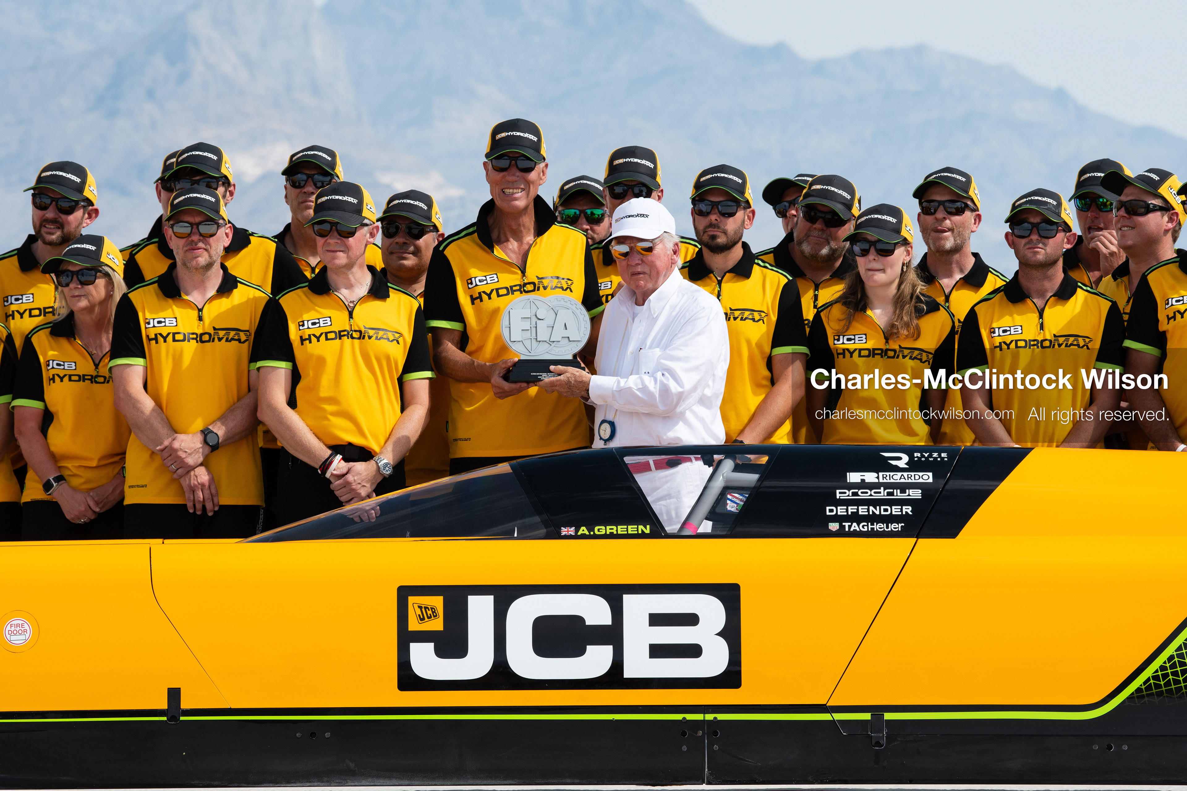 British driver Andy Green receives an official FIA land-speed record trophy from JCB Chairman Anthony Bamford on the Bonneville Salt Flats near Wendover, Utah, on August 11, 2026, after completing high-speed test runs in the hydrogen-powered JCB Hydromax streamliner. (Photo by Charles-McClintock Wilson/NurPhoto)