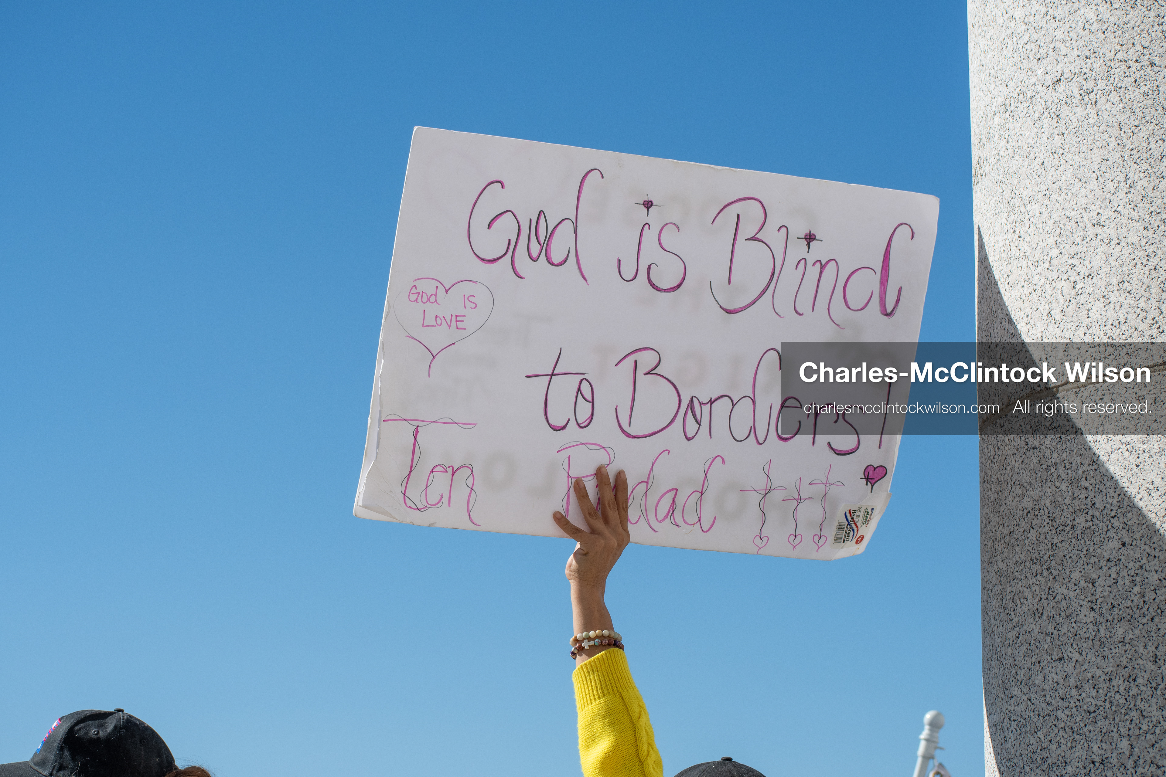 October 18, 2025, Salt Lake City, Utah, USA: A demonstrator raises a placard during a "No Kings" protest held at the Utah State Capitol. Other participants and signs are visible in the background during the public gathering.