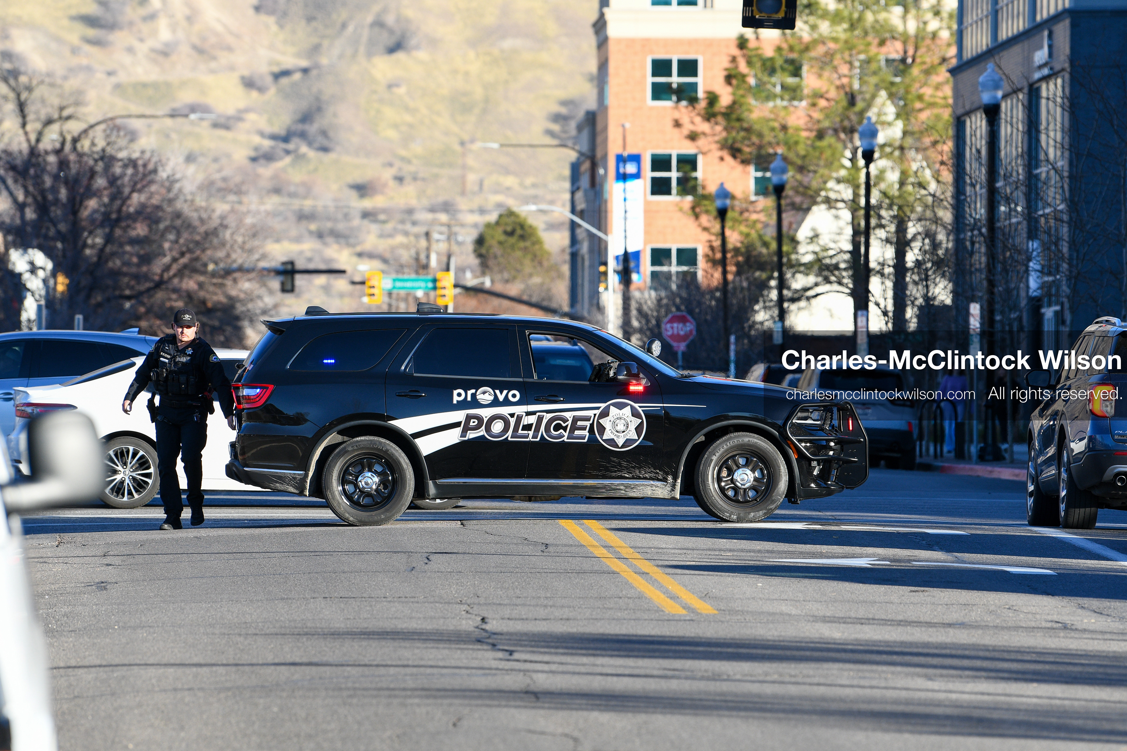PROVO, UTAH, USA – DECEMBER 11, 2025: A Provo Police officer blocks an intersection near the Fourth District Court in Provo during the first in‑person court appearance of Tyler Robinson in the Charlie Kirk murder case. (Credit Image: © Charles‑McClintock Wilson/ZUMA Press Wire)