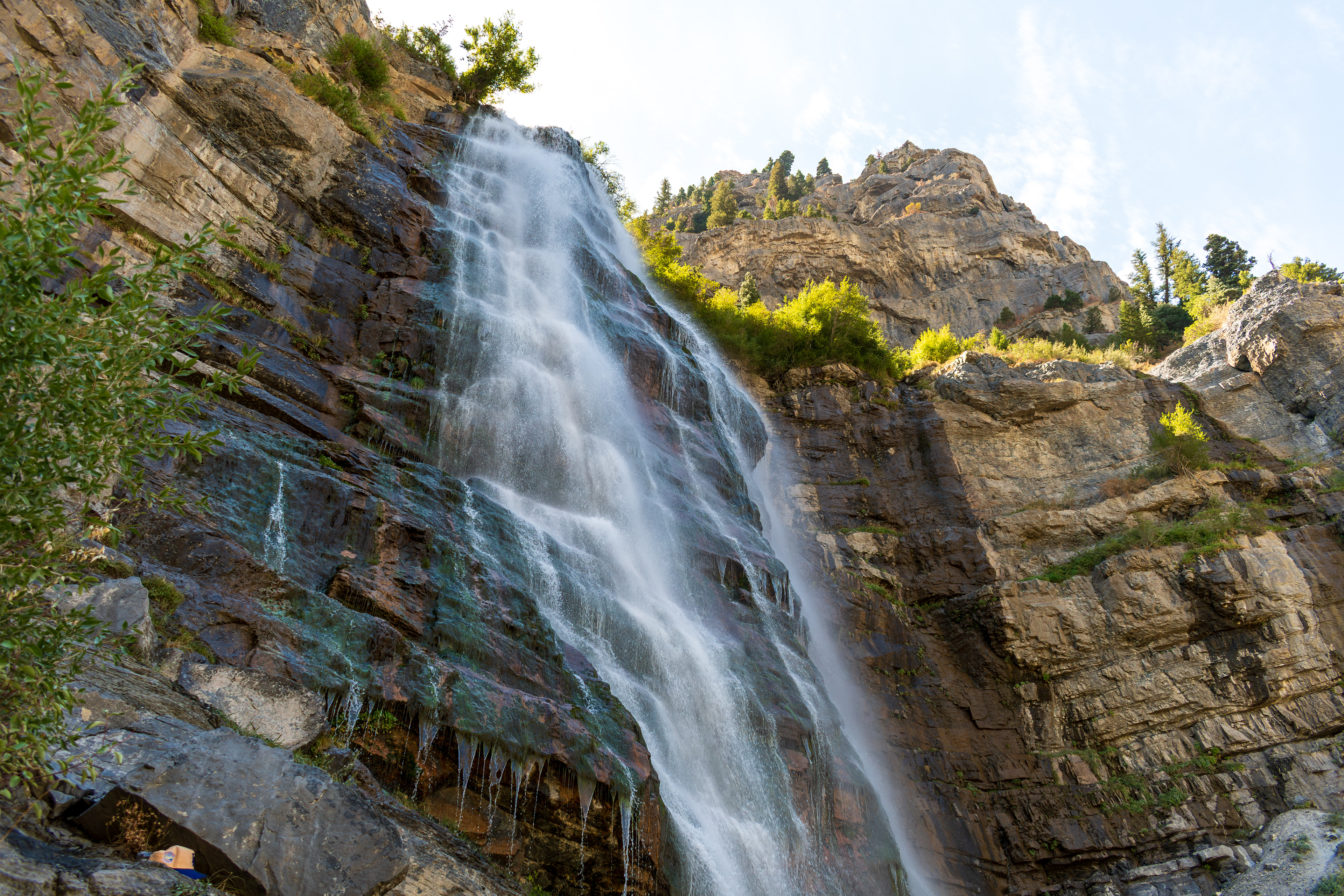 Provo, Utah, USA — September 1, 2025: Bridal Veil Falls cascades down rugged cliffs in a vertical display of height and motion, framed by sparse greenery and exposed rock, in Provo Canyon, Utah. 