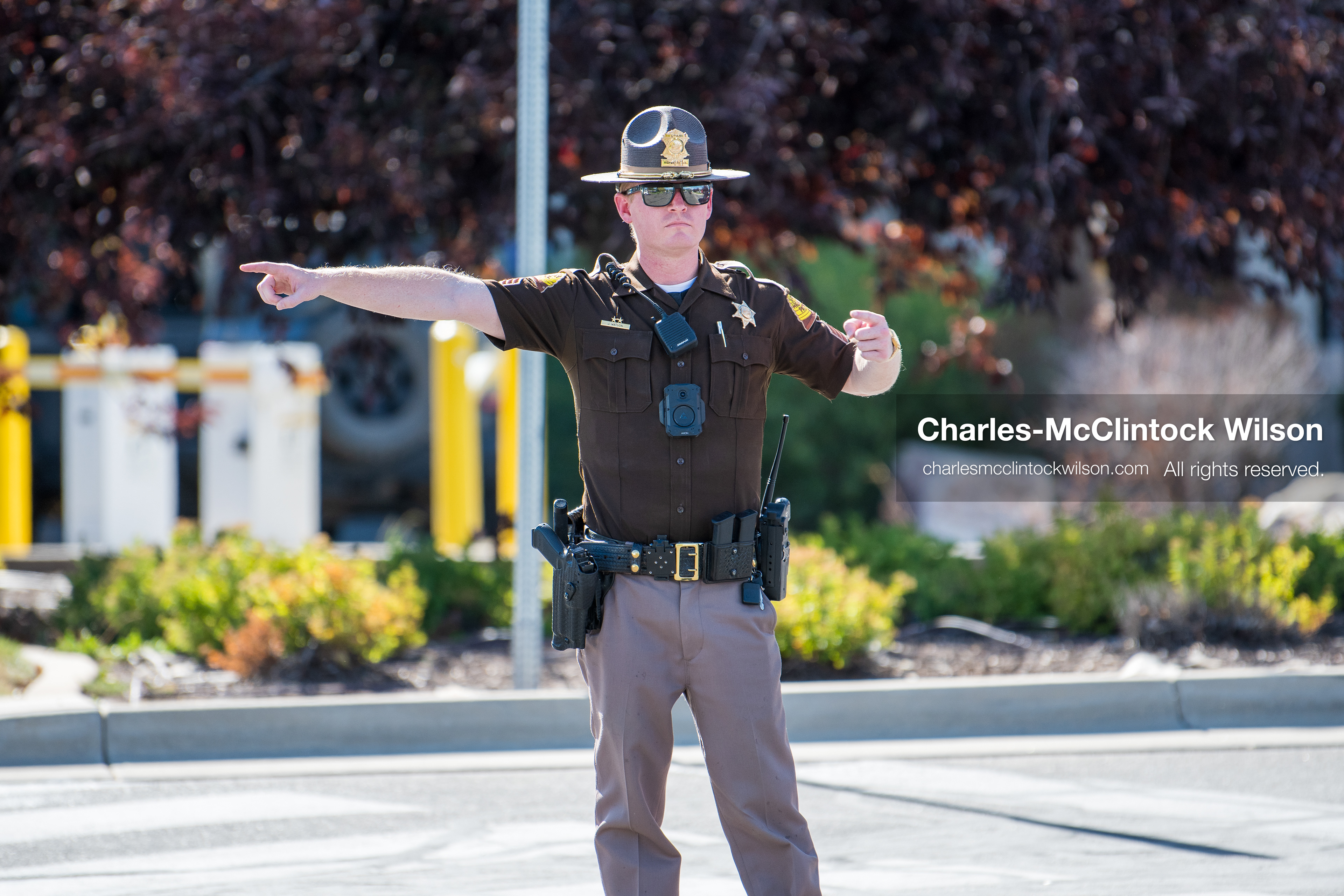 A Utah Highway Patrol trooper points to direct vehicles or individuals at a roadway checkpoint outside Intermountain Medical Center in Murray, Utah, on Monday, August 17, 2026. Multiple regional law enforcement agencies converged to heavily secure the hospital perimeter as a safety precaution after shooting victims arrived from a fatal shootout that erupted outside a funeral service in nearby Kearns earlier that day. (Photo by Charles-McClintock Wilson/Sipa USA)