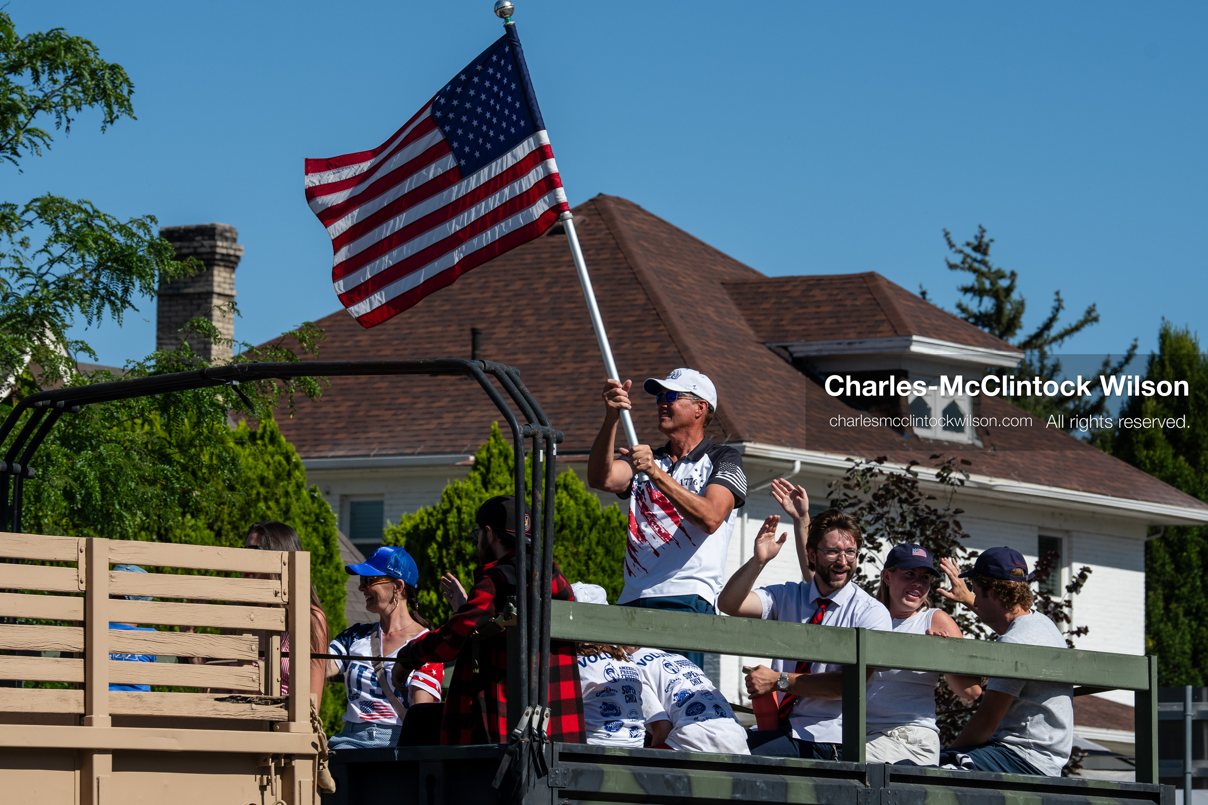 July 4, 2026, Provo, Utah, USA: Parade participants wave an American flag from the back of a moving vehicle during America's Freedom Festival Grand Parade in Provo, Utah, Saturday, July 4, 2026. The annual event drew thousands of spectators to the downtown corridor. (Credit Image: © Charles-McClintock Wilson/ZUMA Press Wire)