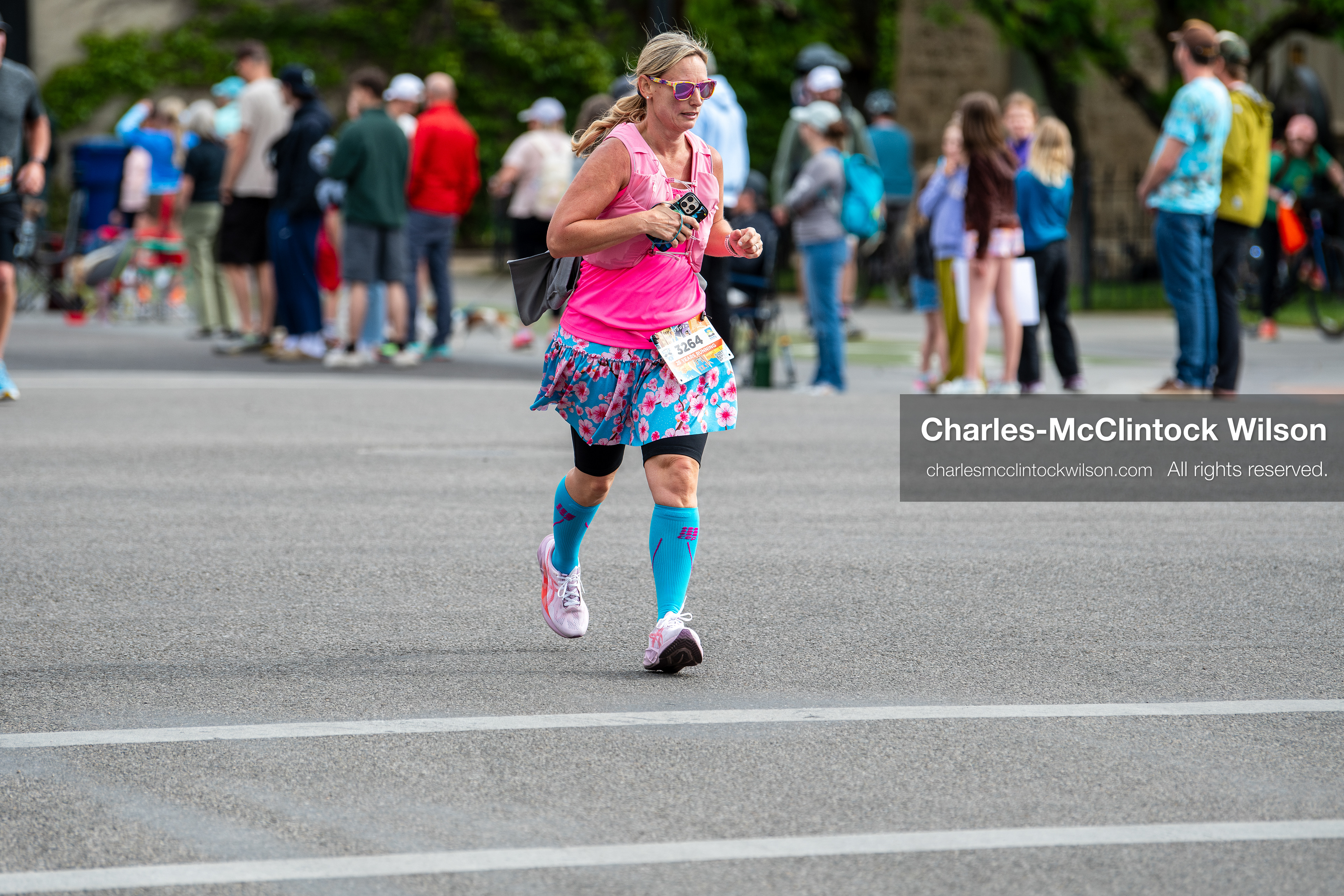 May 16, 2026, Ogden, Utah, USA: A runner wearing a bright pink top and patterned skirt competes in the 25th Annual America First Ogden Marathon in Ogden, Utah, on Saturday, May 16, 2026. Spectators line the course behind barricades as participants make their way through downtown streets during the milestone 25th running of the event. (Credit Image: © Charles-McClintock Wilson/ZUMA Press Wire)