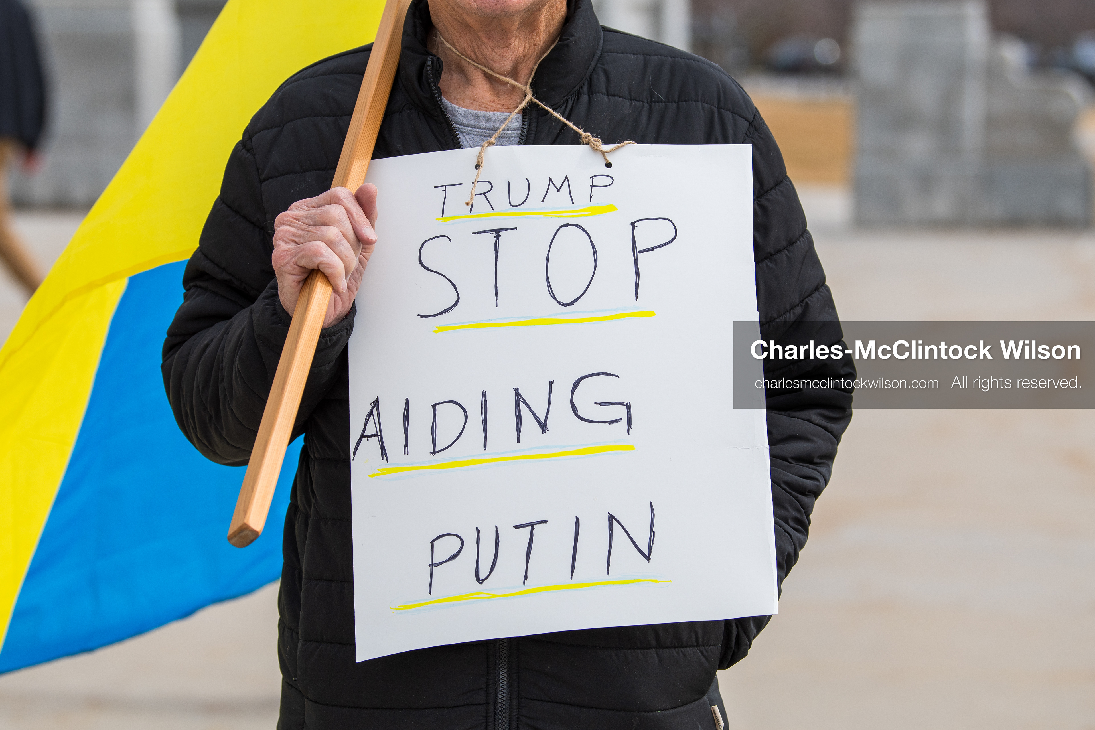 February 28, 2026, Salt Lake City, Utah, USA: A demonstrator wears a sign reading Trump Stop Aiding Putin during the Stand With Ukraine rally at the Utah State Capitol. The gathering marked the four year anniversary of the full scale Russian invasion of Ukraine and brought community members together in support of Ukrainians and local humanitarian efforts. (Credit Image: © Charles McClintock Wilson/ZUMA Press Wire)