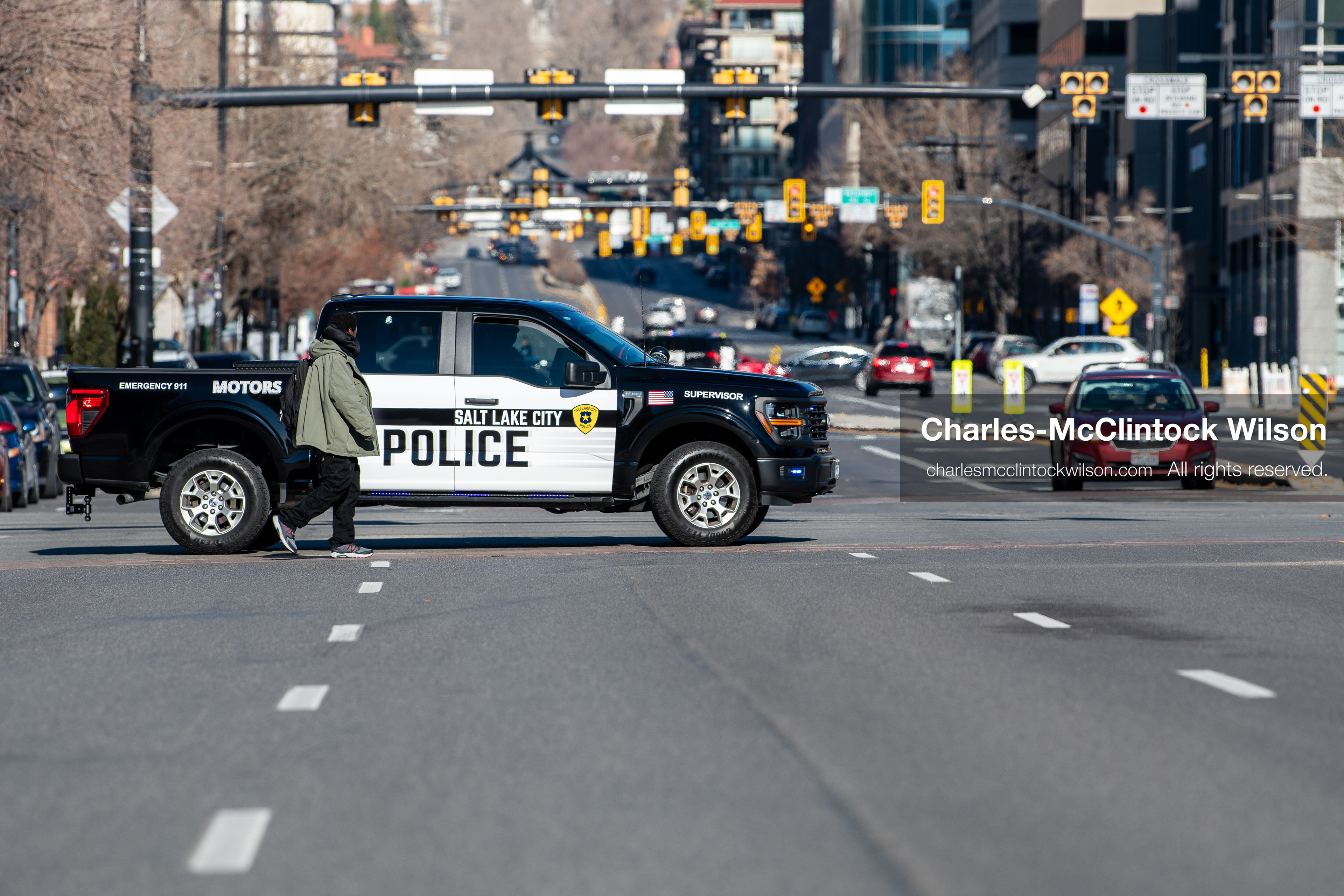 Salt Lake City, Utah, January 10, 2026: A Salt Lake City Police Department vehicle blocks Main Street near Washington Square Park as a pedestrian walks past during the ICE Out for Good protest, a demonstration calling for justice for Renee Nicole Good. (Credit Image: © Charles‑McClintock Wilson/ZUMA Press Wire)