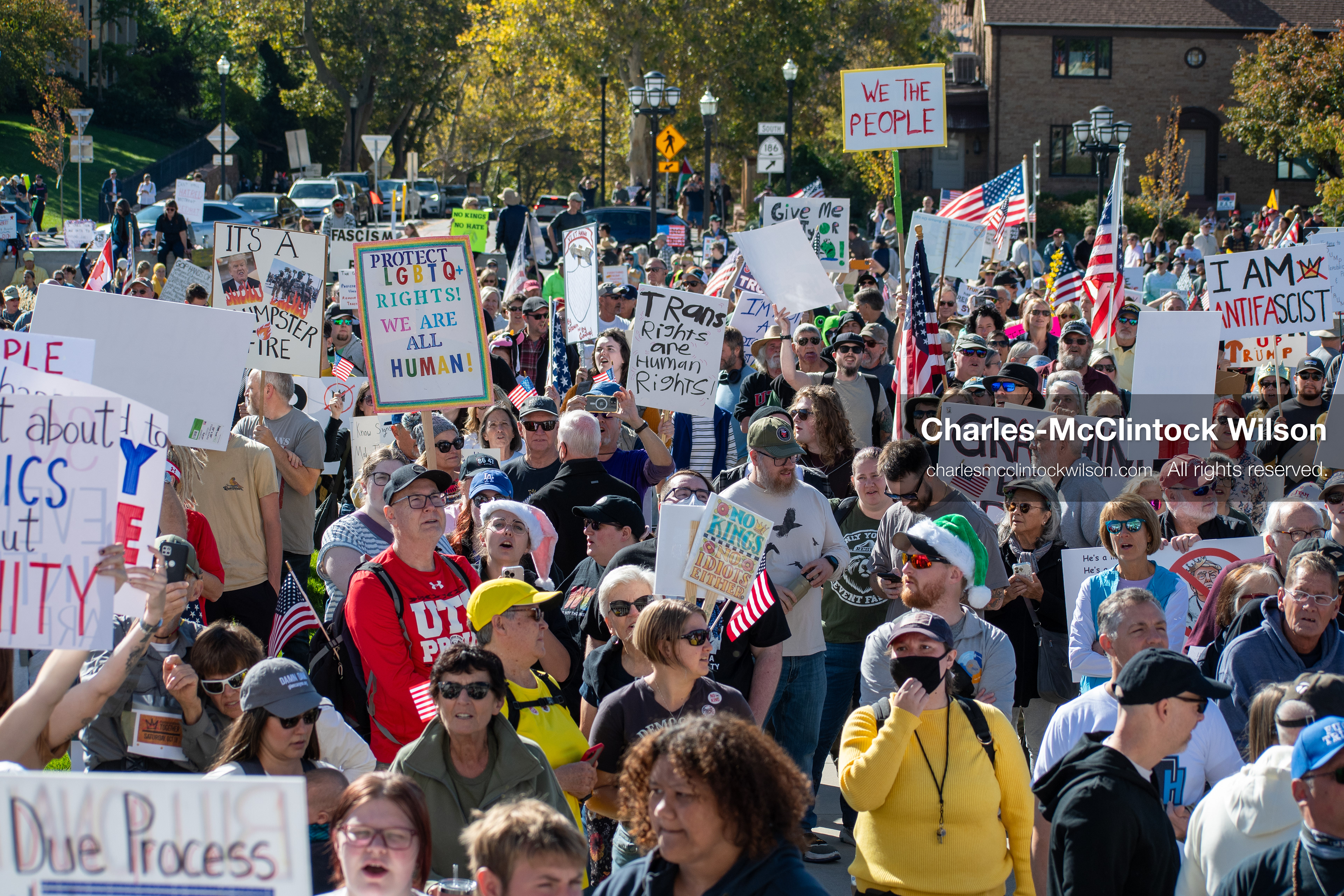 October 18, 2025, Salt Lake City, Utah, USA: Demonstrators gather on the steps of the Utah State Capitol during a "No Kings" protest held as part of a nationwide mobilization. Participants hold signs and flags while documenting the event. The protest was one of several organized across the United States.