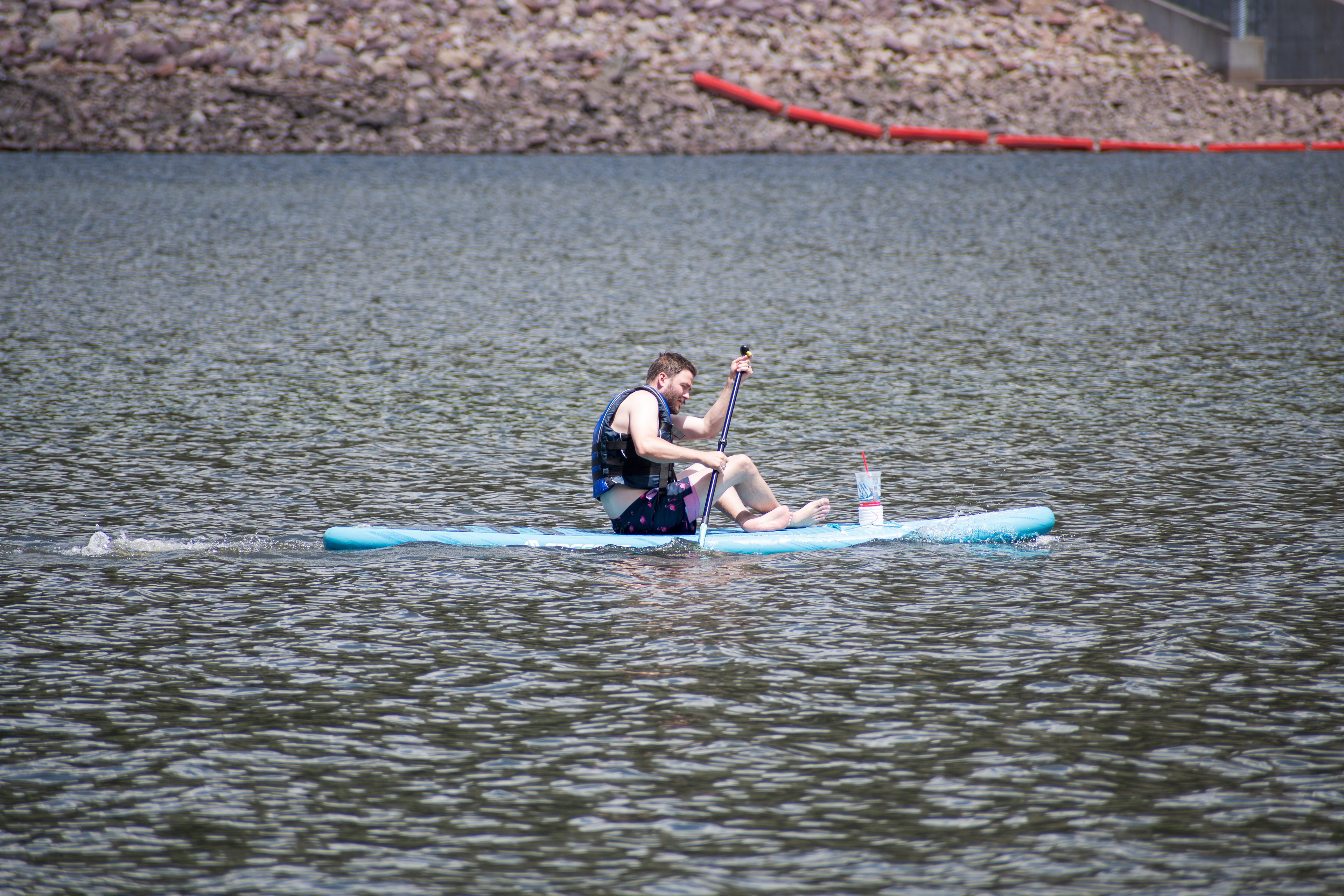 Summit County, Utah – July 20, 2025: A man paddleboards across the water at Smith and Morehouse Reservoir. 