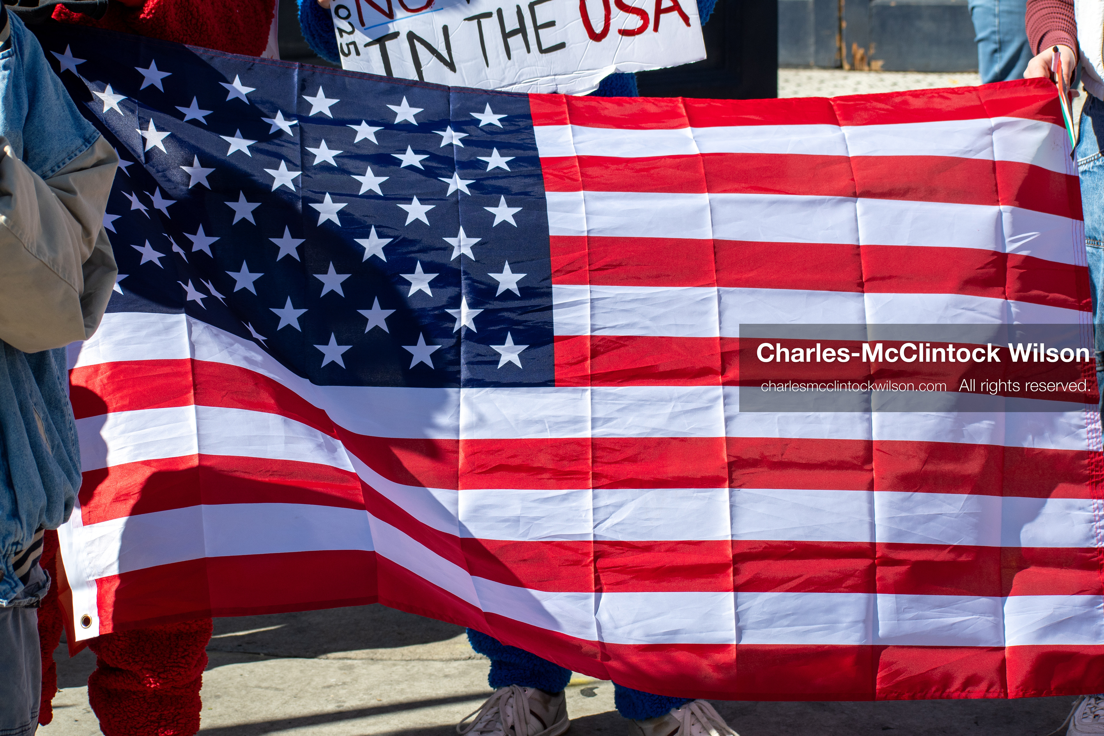 October 18, 2025, Salt Lake City, Utah, USA: Demonstrators display an American flag during a "No Kings" protest in Salt Lake City, Utah. The protest was part of a nationwide mobilization.