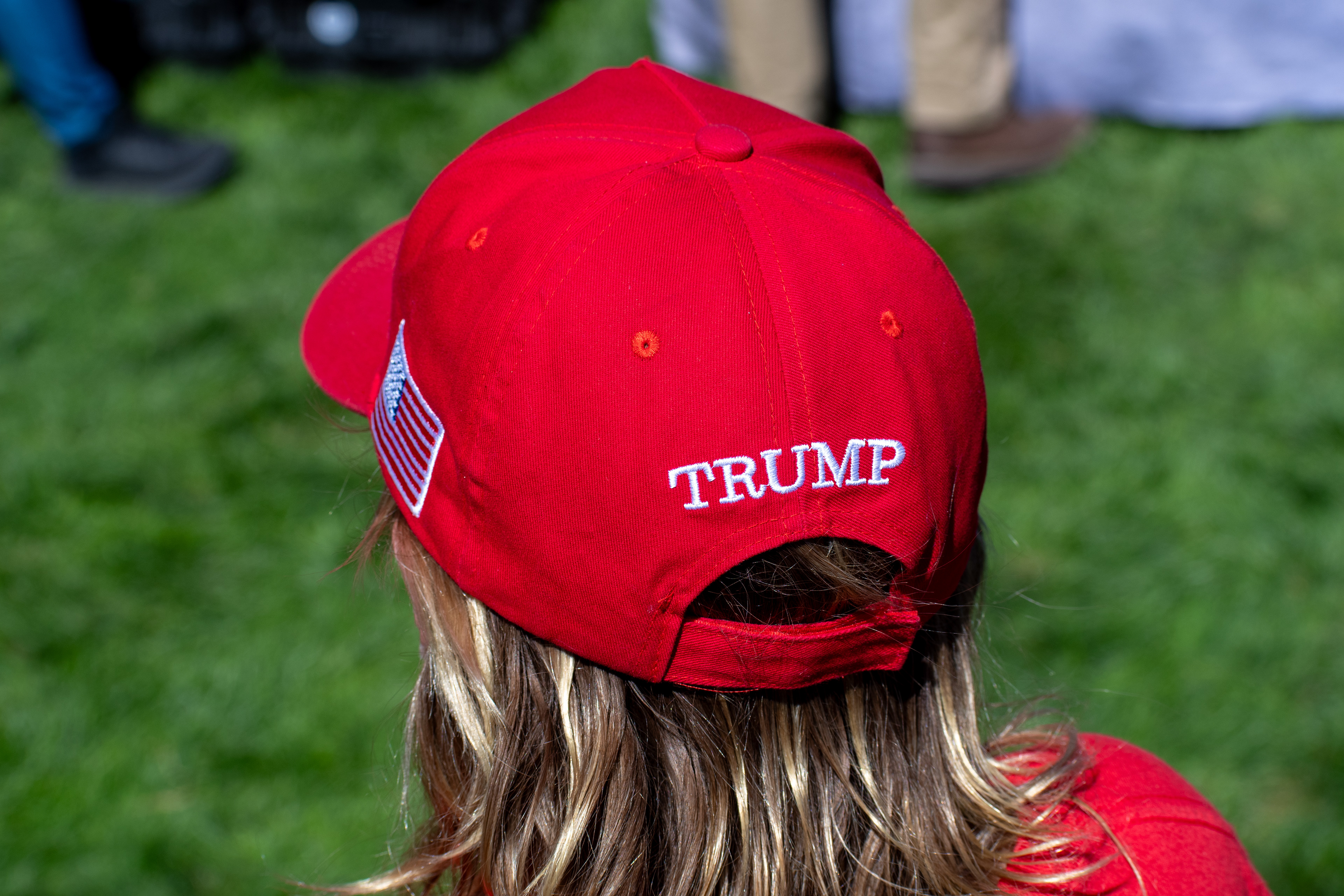 OREM, UTAH – SEPTEMBER 10, 2025: An attendee stands quietly on the lawn at Utah Valley University during the opening stop of the American Comeback Tour. Framed from behind, the image captures a moment of stillness and personal presence amid the larger gathering. It reflects the emotional texture and civic anticipation that shaped the event’s intended spirit. © Charles-McClintock Wilson / ZUMA Press