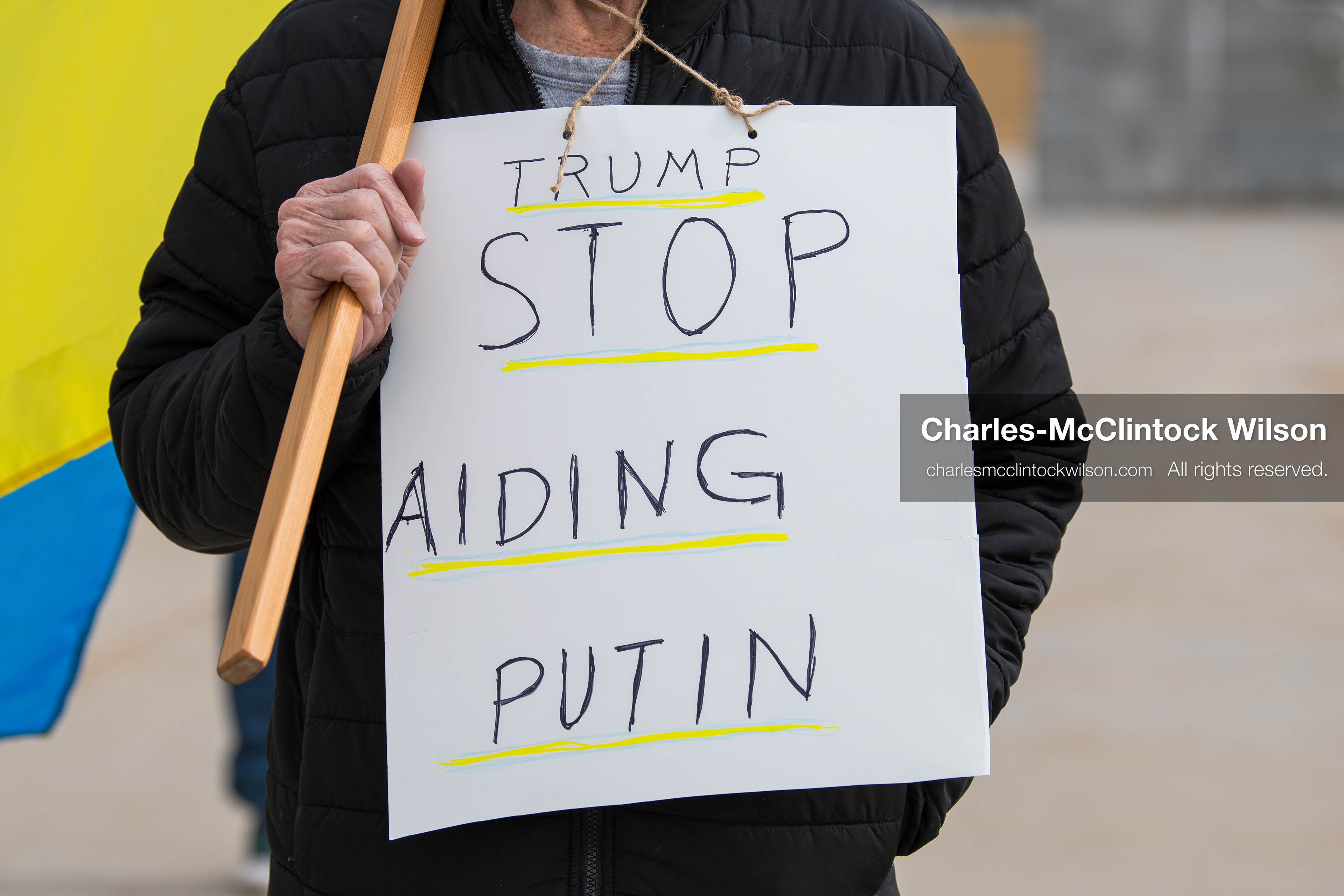 February 28, 2026, Salt Lake City, Utah, USA: A demonstrator wears a sign reading Trump Stop Aiding Putin during the Stand With Ukraine rally at the Utah State Capitol. The gathering marked the four year anniversary of the full scale Russian invasion of Ukraine and brought community members together in support of Ukrainians and local humanitarian efforts. (Credit Image: © Charles McClintock Wilson/ZUMA Press Wire)