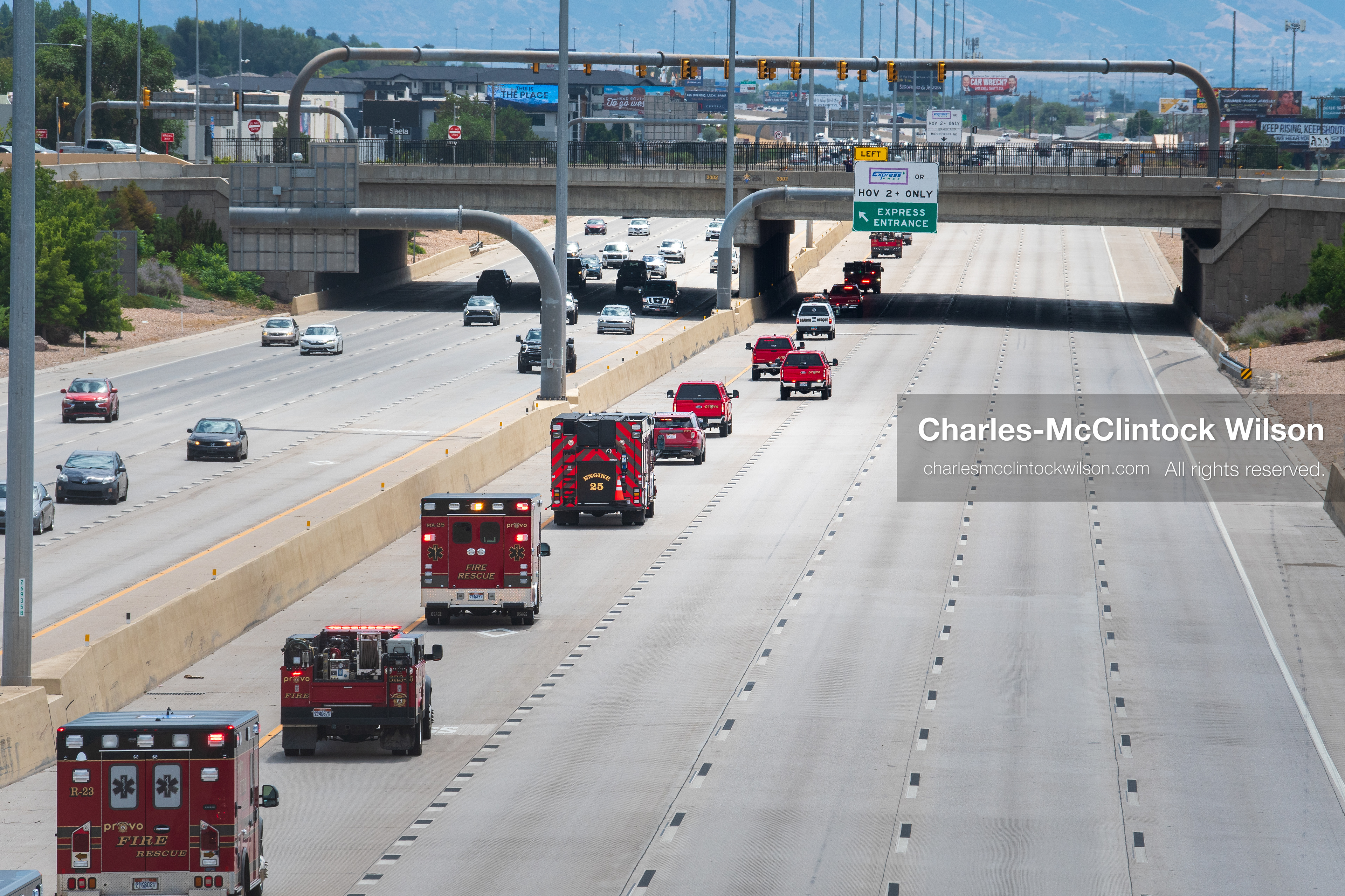 A long line of fire engines and emergency response vehicles travels in a single file column along the express lane of Interstate 15 during a funeral procession for Provo Fire Captain Spencer Long and his family in Orem, Utah, on Wednesday, July 29, 2026. More than 300 people came to the public memorial ceremony to honor the five family members who died after a flash flood hit their campsite near the Sunglow Campground in Wayne County. (Photo by Charles-McClintock Wilson/Sipa USA)