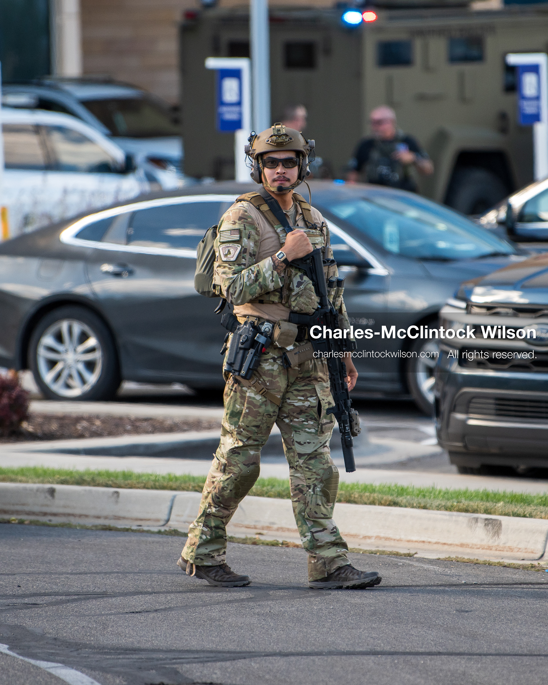An armed law enforcement officer wearing a helmet and tactical gear stands guard outside Intermountain Medical Center in Murray, Utah, United States, on August 17, 2026. Multiple regional police agencies secured the hospital perimeter as a safety precaution after shooting victims were admitted following a fatal shootout outside a funeral service in nearby Kearns. (Photo by Charles-McClintock Wilson/NurPhoto)