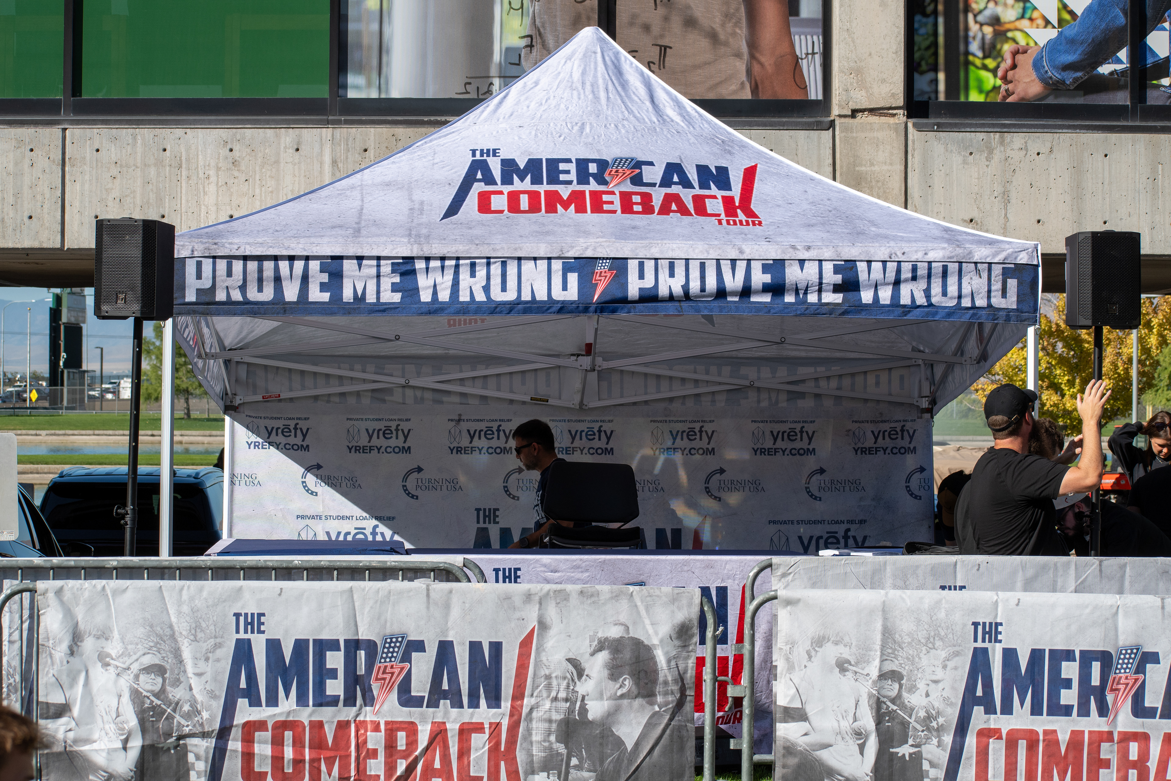 OREM, UTAH – SEPTEMBER 10, 2025: A branded tent stands outside the student center at Utah Valley University during the opening stop of the American Comeback Tour. Featuring bold signage and coordinated barriers, the setup reflects a moment of visual messaging, logistical precision, and public invitation. The image captures the infrastructure and thematic clarity that shaped the event’s atmosphere. © Charles-McClintock Wilson / ZUMA Press