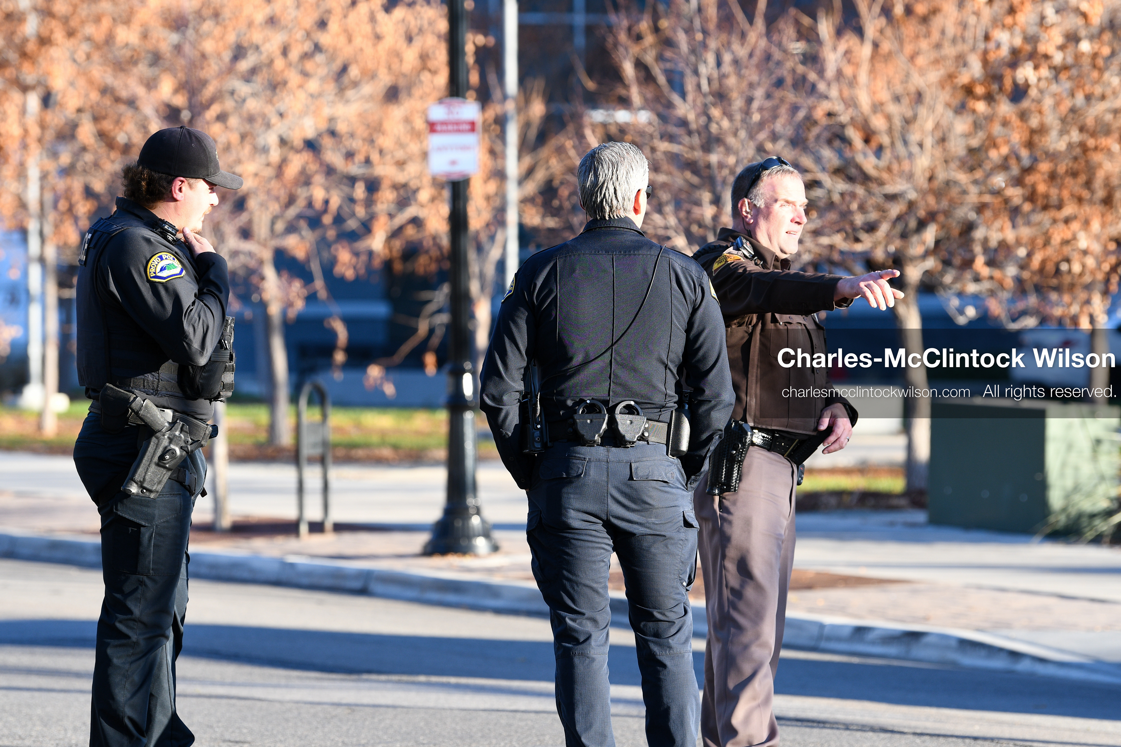 PROVO, UTAH, USA – DECEMBER 11, 2025: Two Provo Police officers and a Utah Highway Patrol officer stand outside the Fourth District Court in Provo during the first in‑person court appearance of Tyler Robinson in the Charlie Kirk murder case. (Credit Image: © Charles‑McClintock Wilson/ZUMA Press Wire)