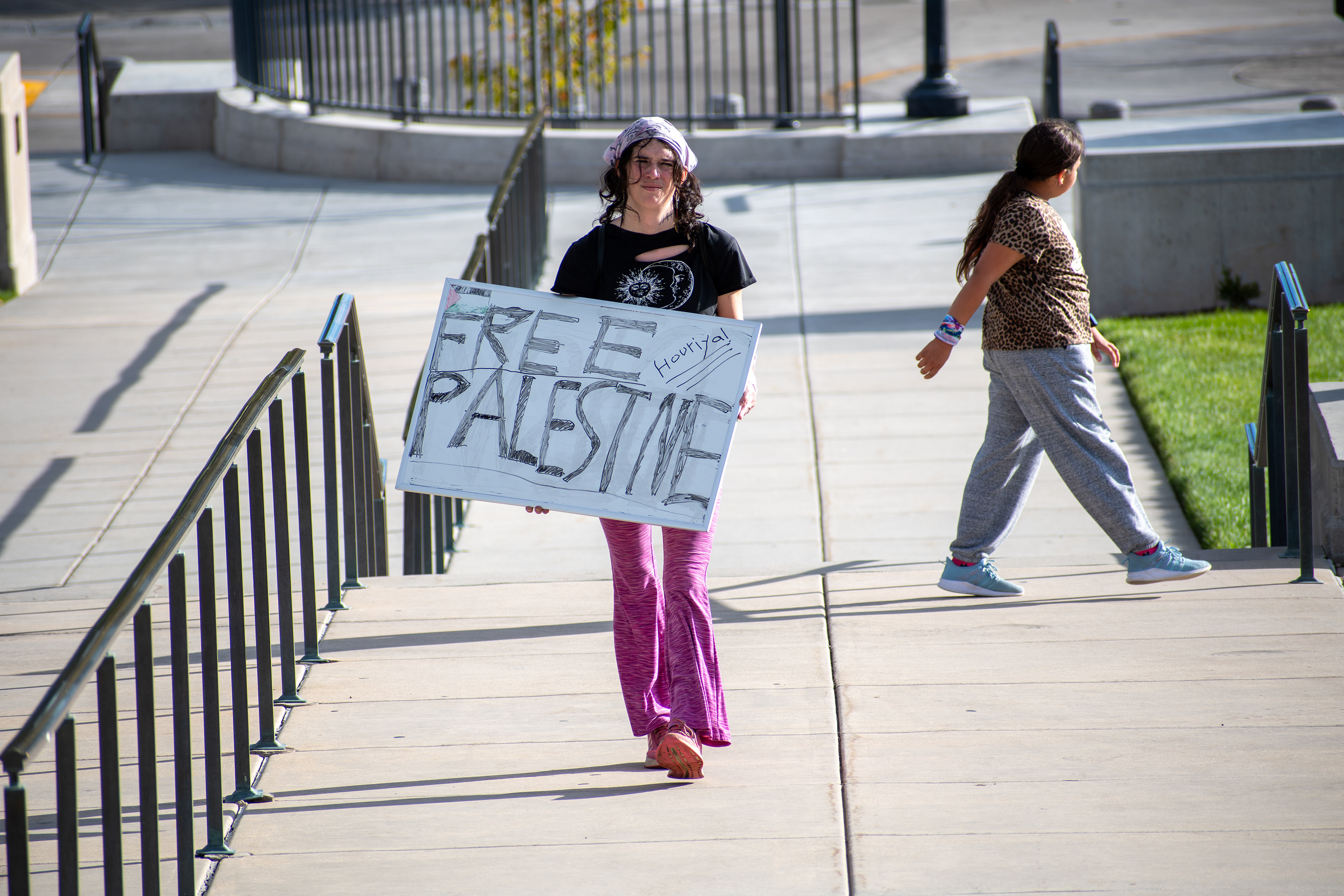 October 10, 2025, Salt Lake City, Utah, USA: A demonstrator walks on a paved walkway during the Free Palestine Rally organized in front of the Utah State Capitol. The participant holds a sign featuring symbolic colors and handwritten messages. (Credit Image: © Charles-McClintock Wilson/ZUMA Press Wire)