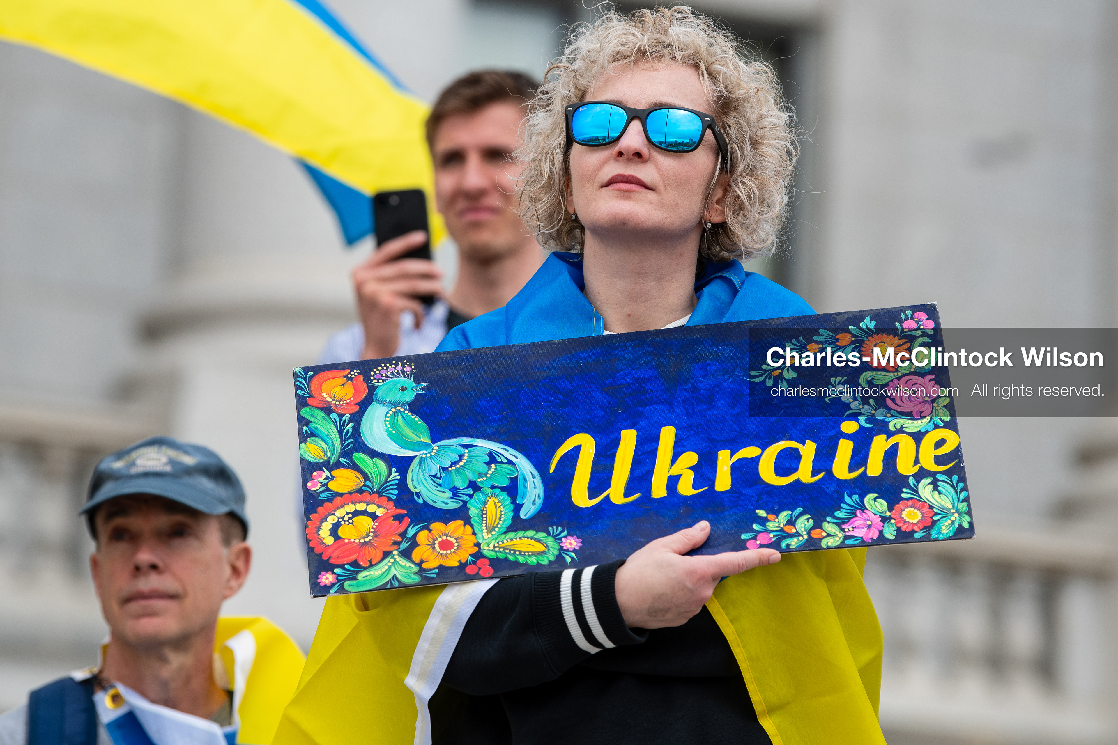 February 28, 2026, Salt Lake City, Utah, USA: A demonstrator draped in a Ukrainian flag holds a hand painted sign reading Ukraine during the Stand With Ukraine rally at the Utah State Capitol. The gathering marked the four year anniversary of the full scale Russian invasion of Ukraine and brought community members together in support of Ukrainians and local humanitarian efforts. (Credit Image: © Charles McClintock Wilson/ZUMA Press Wire)