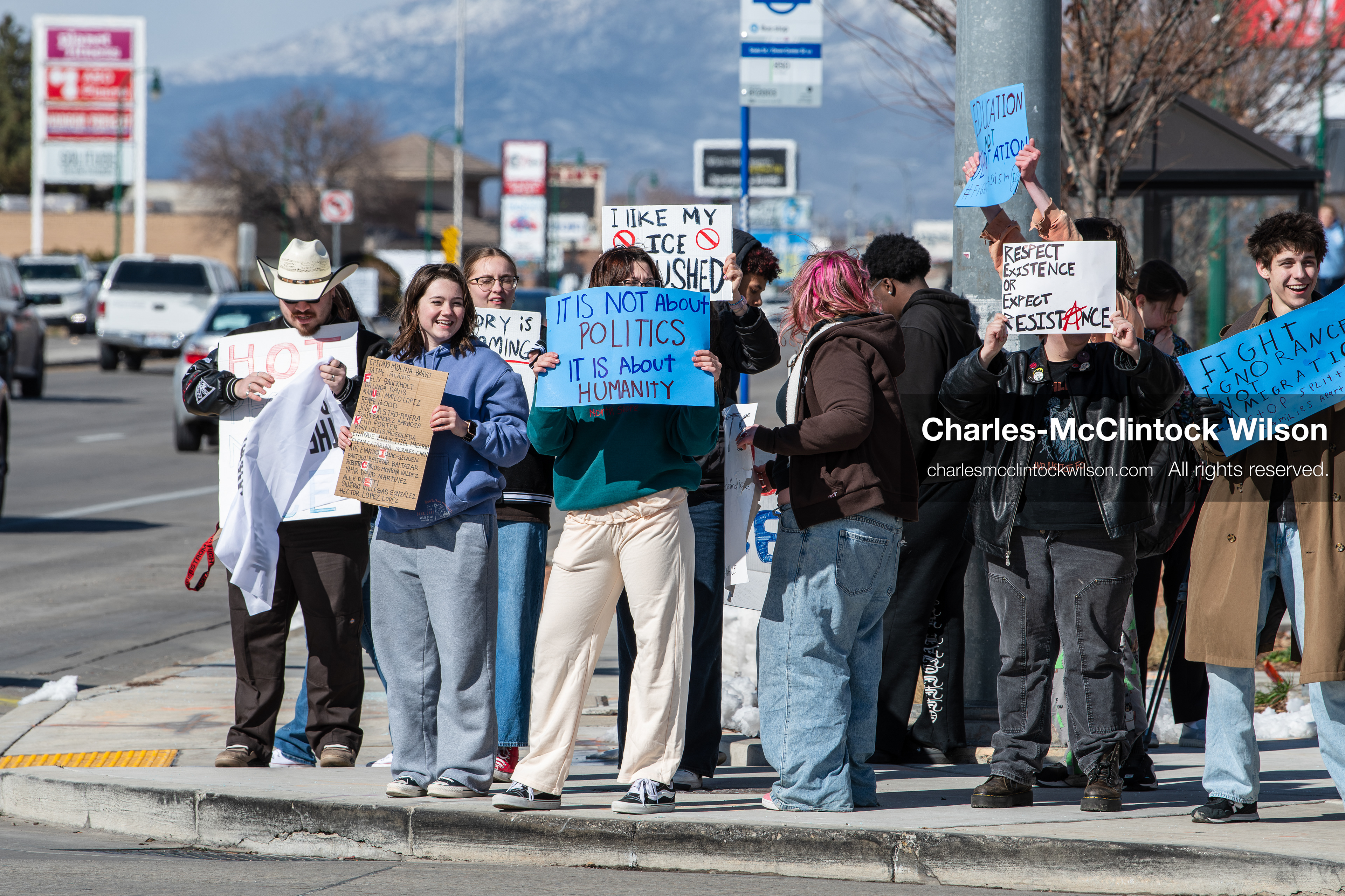 February 20, 2026, Orem, Utah, USA: High school students gather along State Street in front of Orem City Hall during a student led protest against ICE and federal immigration enforcement. Demonstrators hold signs as they stand near the roadway while traffic continues through the area. (Credit Image: © Charles McClintock Wilson/ZUMA Press Wire)