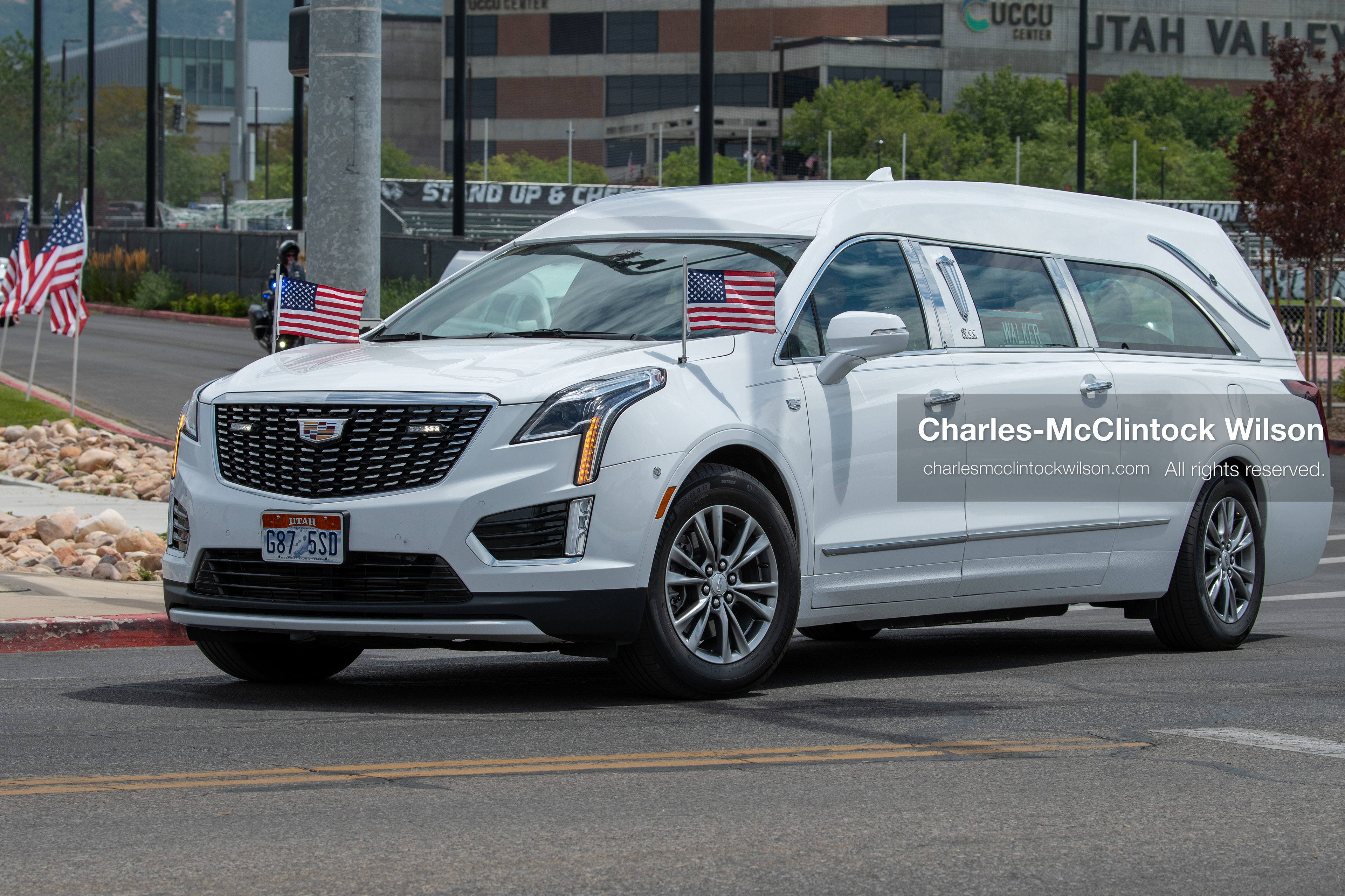 A white Cadillac hearse leads a vehicle procession down the street away from the UCCU Center at Utah Valley University in Orem, Utah, on Wednesday, July 29, 2026. More than 300 people came to the public memorial ceremony to honor Provo Fire Captain Spencer Long, his wife Katrina, and three of their sons, who died after a flash flood hit their campsite near the Sunglow Campground in Wayne County.(Photo by Charles-McClintock Wilson/Sipa USA)